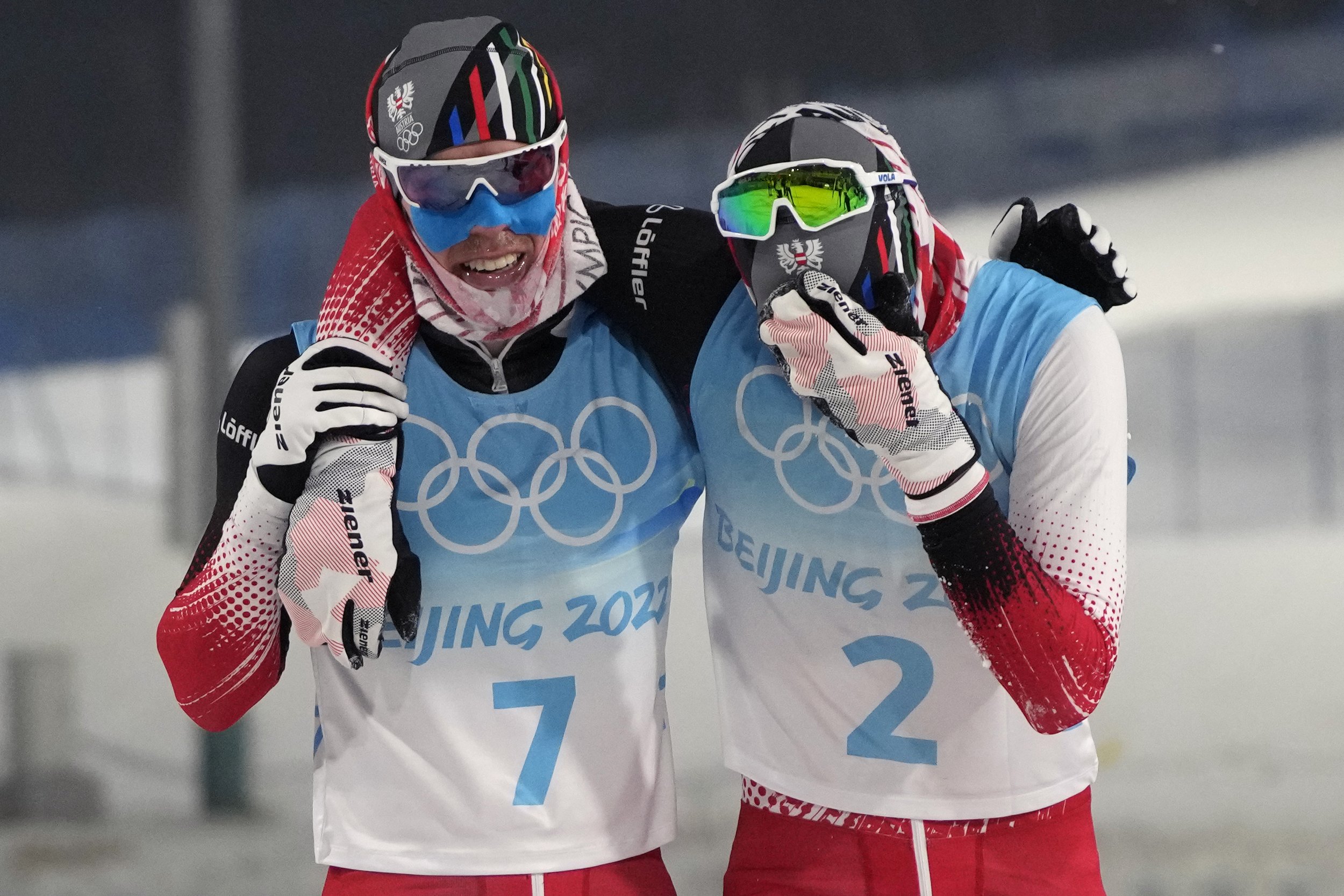  Austria's Franz-Josef Rehrl, left, celebrates with bronze medal finisher Austria's Lukas Greiderer, right, after the cross-country skiing portion of the individual Gundersen normal hill/10km event at the 2022 Winter Olympics, Wednesday, Feb. 9, 2022