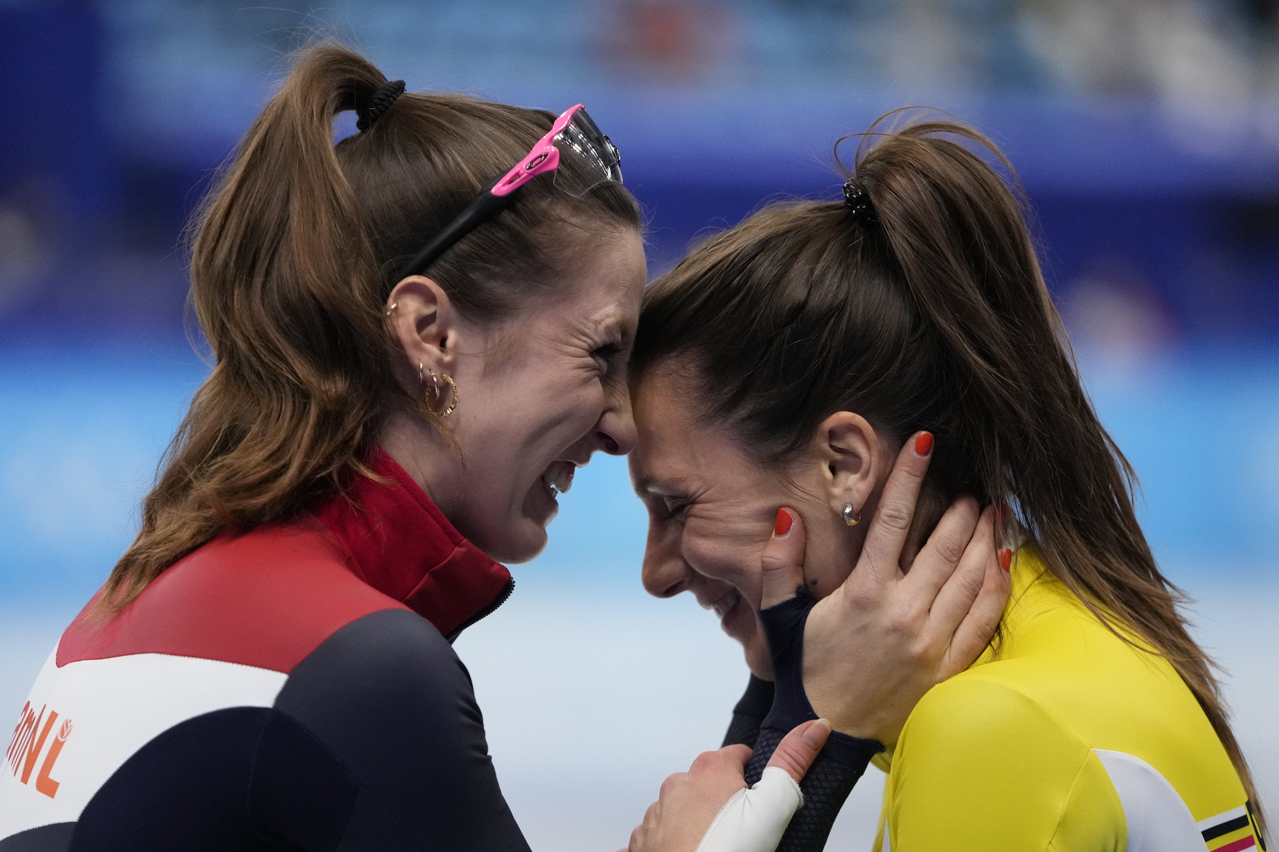  Suzanne Schulting, left, of the Netherlands, embraces Hanne Desmet of Belgium, after winning the women's 1000-meters during the short track speedskating competition at the 2022 Winter Olympics, Friday, Feb. 11, 2022, in Beijing. (AP Photo/Natacha Pi