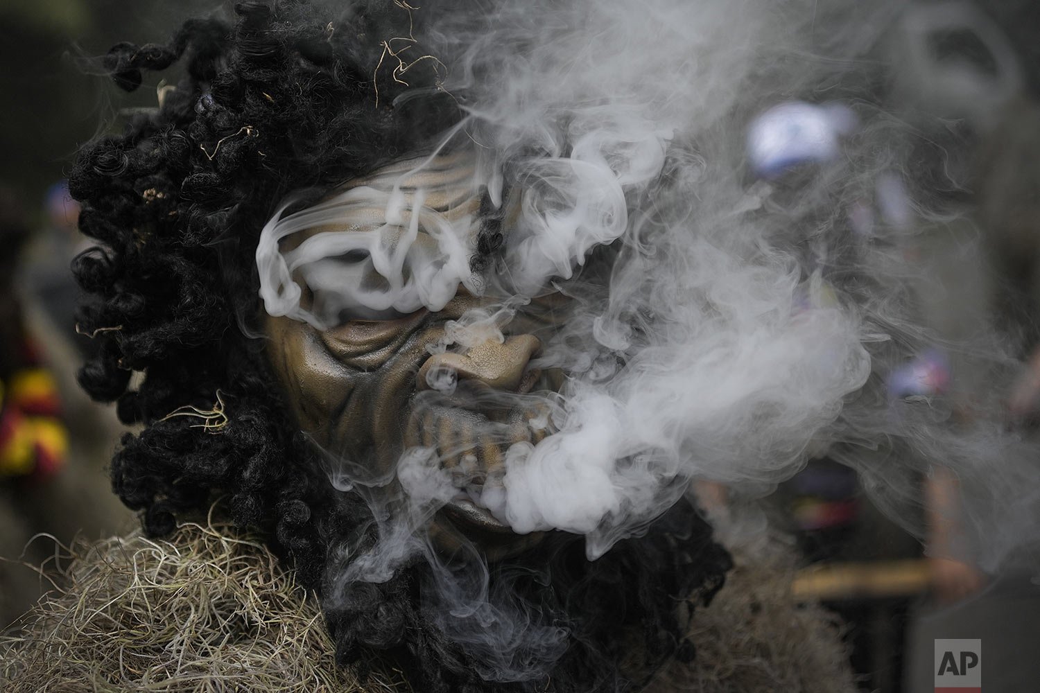  A man in a gorilla costume smokes before the start of a Carnival parade in Colonia Tovar, Venezuela, Feb. 26, 2022. People poured onto the streets of this German-founded village to enjoy a parade of people dressed as harlequin-like figures and as go
