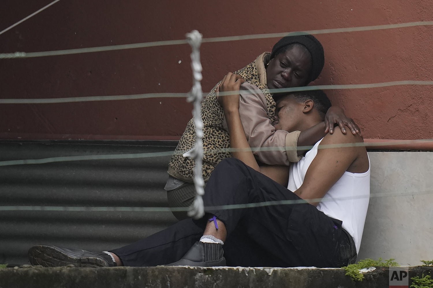  A woman embraces a youth after fatal mudslides in Petropolis, Brazil, Feb. 16, 2022. (AP Photo/Silvia Izquierdo) 