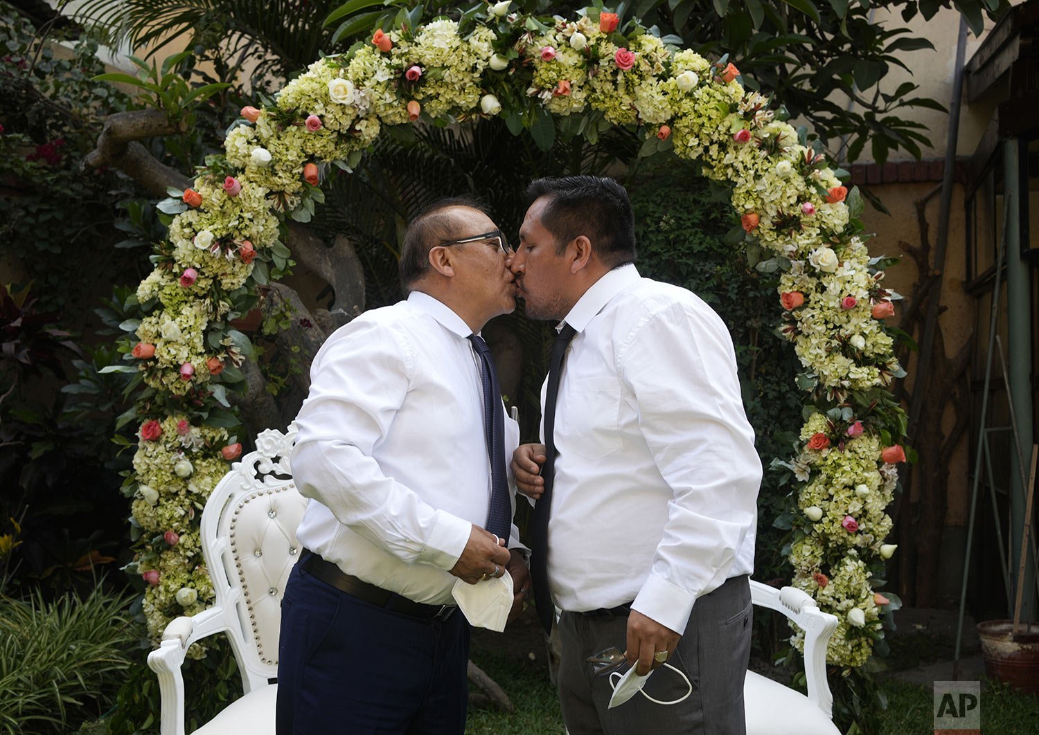  Juan Alfonso, left, kisses his partner Miguel Angel during a symbolic gay wedding ceremony, organized by Peru's LGBT community to promote same-sex marriage, ahead of the feast of Saint Valentine in Lima, Feb. 12, 2022. Same-sex marriage is not legal