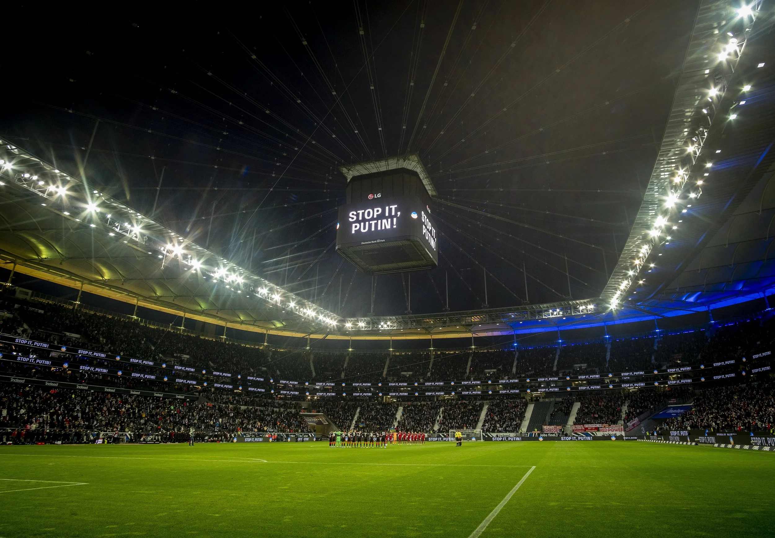  Teams take a minute of silence in support of Ukraine ahead of a German Bundesliga soccer match between Eintracht Frankfurt and Bayern Munich in Frankfurt, Germany, Saturday, Feb. 26, 2022. (AP Photo/Michael Probst) 