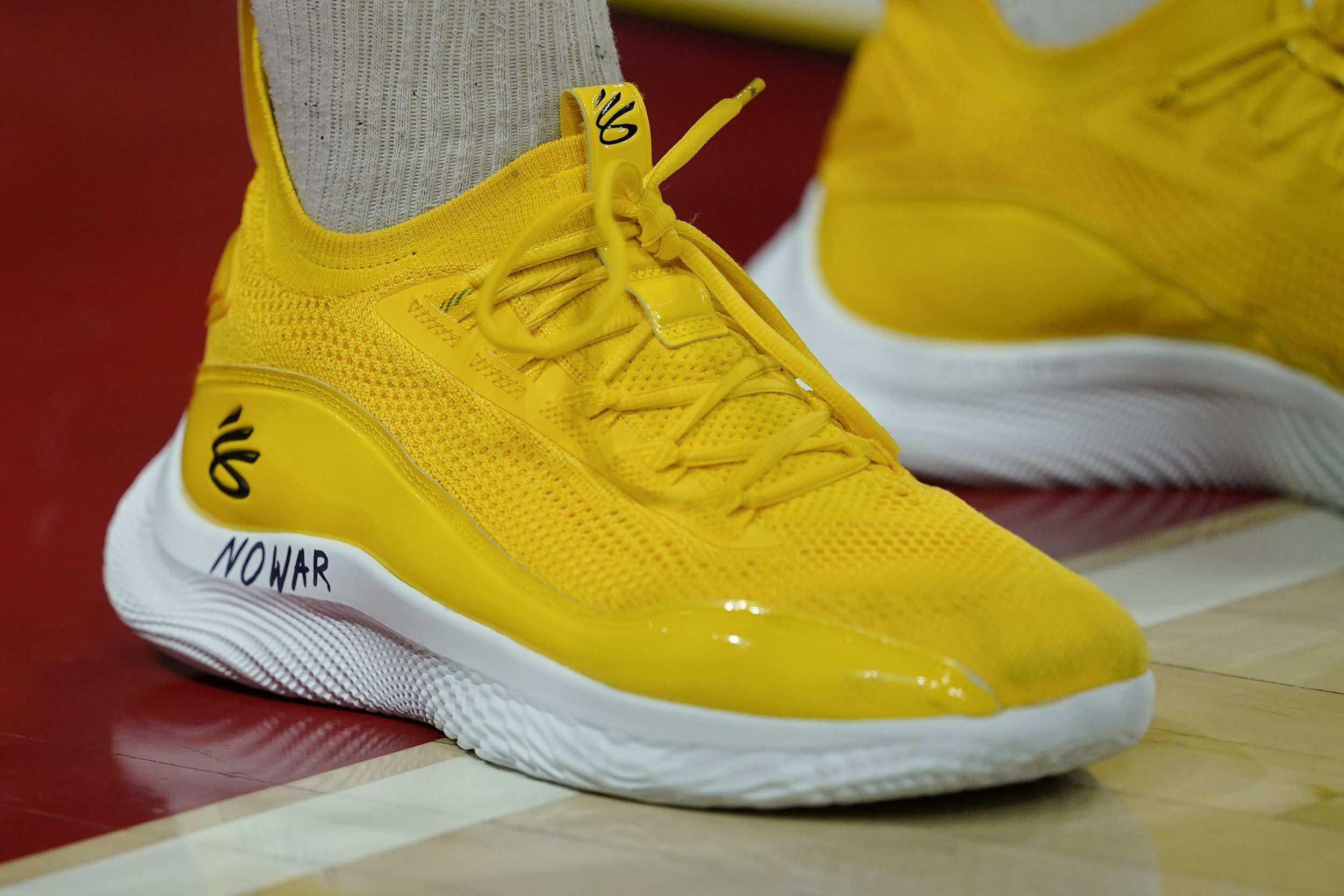  The words "No War" are written on the shoes of Maryland forward Pavlo Dziuba, who was born in Kyiv, Ukraine, as he stands for the United States national anthem prior to an NCAA college basketball game against Ohio State, Feb. 27, 2022, in College Pa