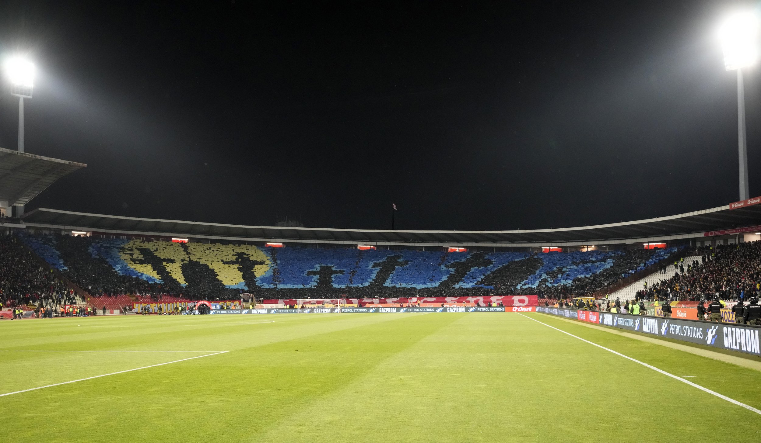  Red Star fans form an image of a gravestones in yellow and blue colors before a Serbian National soccer league derby match between Red Star and Partizan in Belgrade, Serbia, Sunday, Feb. 27, 2022. (AP Photo/Darko Vojinovic) 