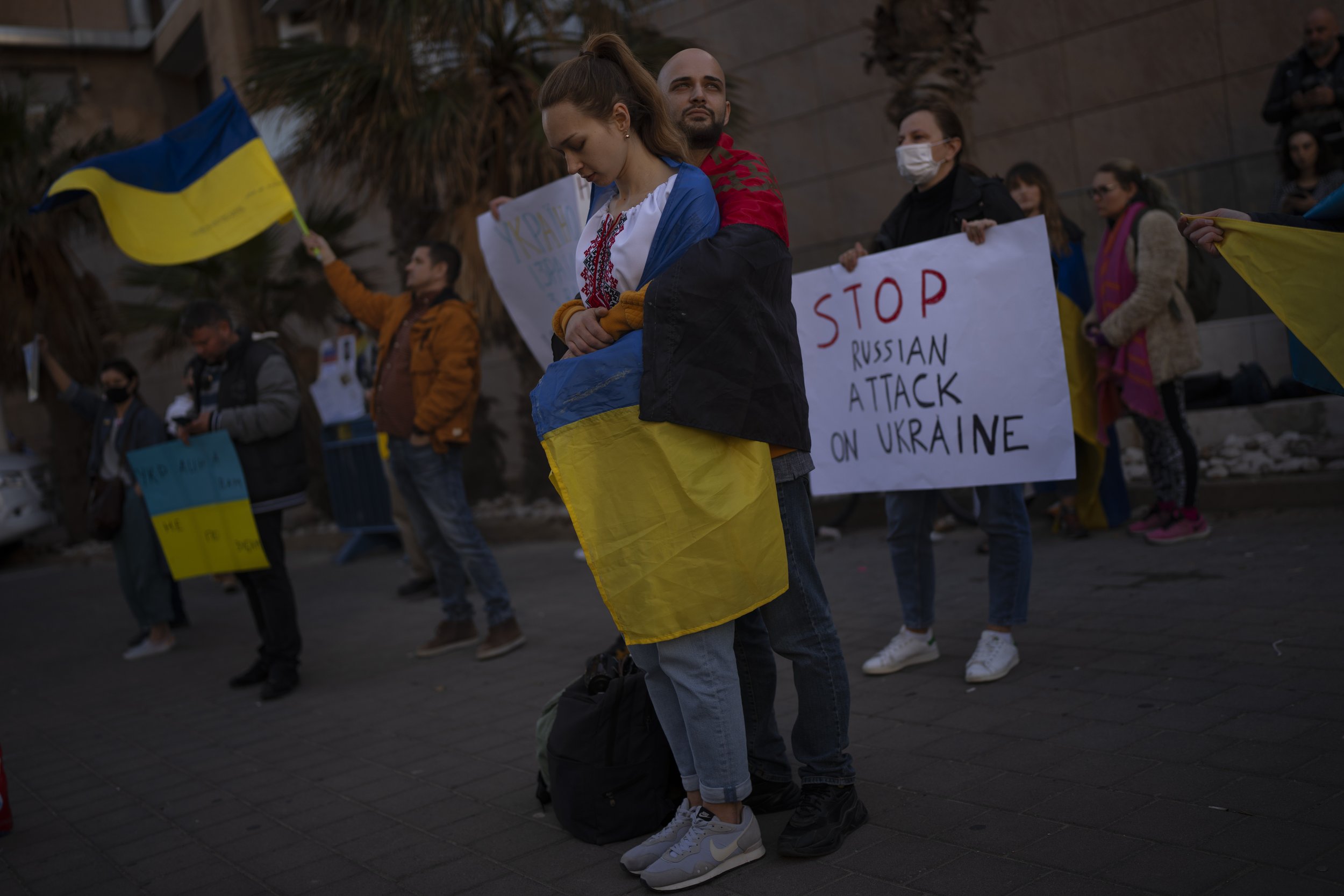  Demonstrators hold placards and flags as they attend a pro-Ukraine protest outside the Russian Embassy, after Russian troops have launched their anticipated attack on Ukraine, in Tel Aviv, Israel, Thursday, Feb. 24, 2022. (AP Photo/Oded Balilty) 