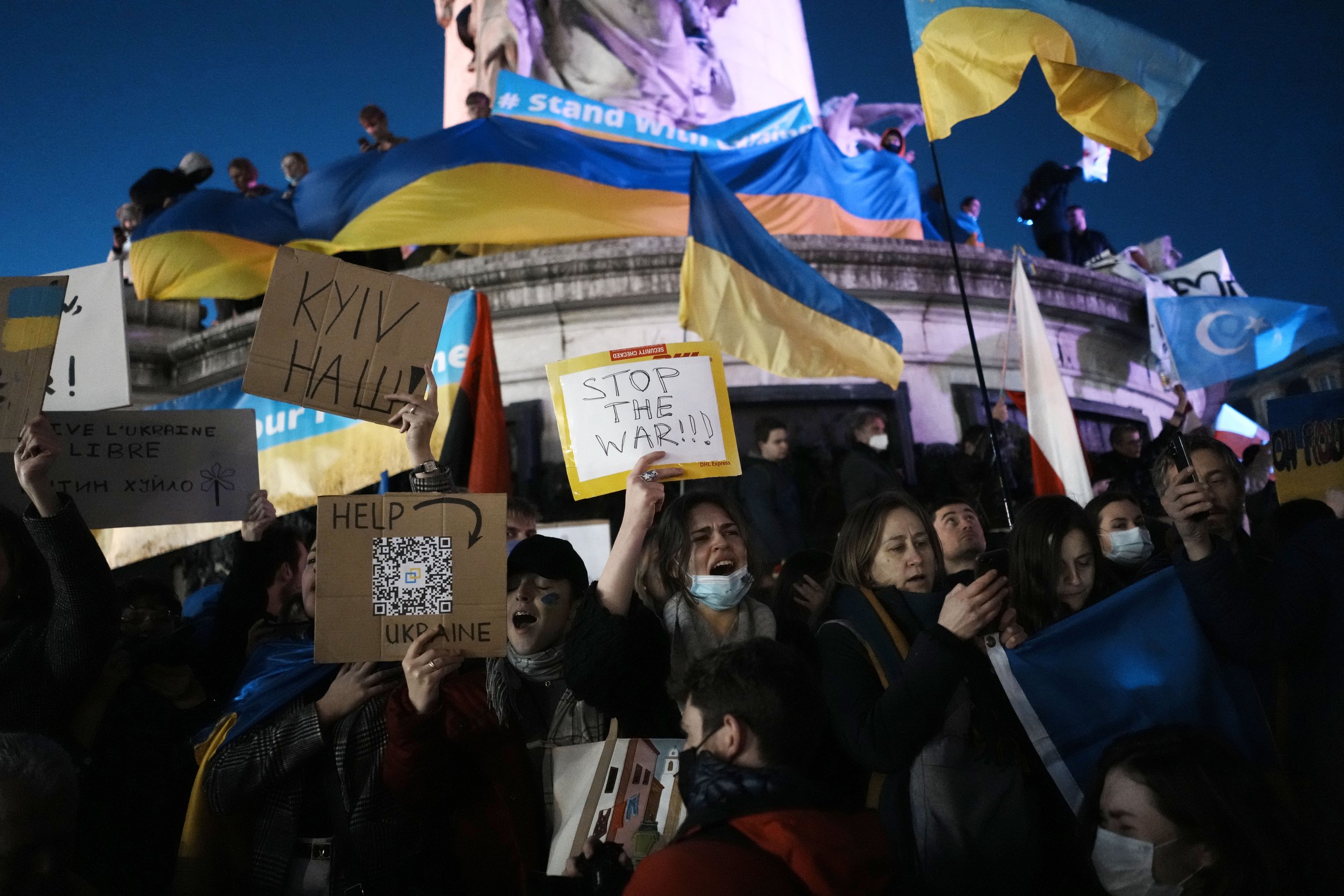  People hold Ukrainian flags and placards as they gather in support of Ukrainian people, in Paris, Thursday, Feb. 24, 2022. (AP Photo/Thibault Camus) 