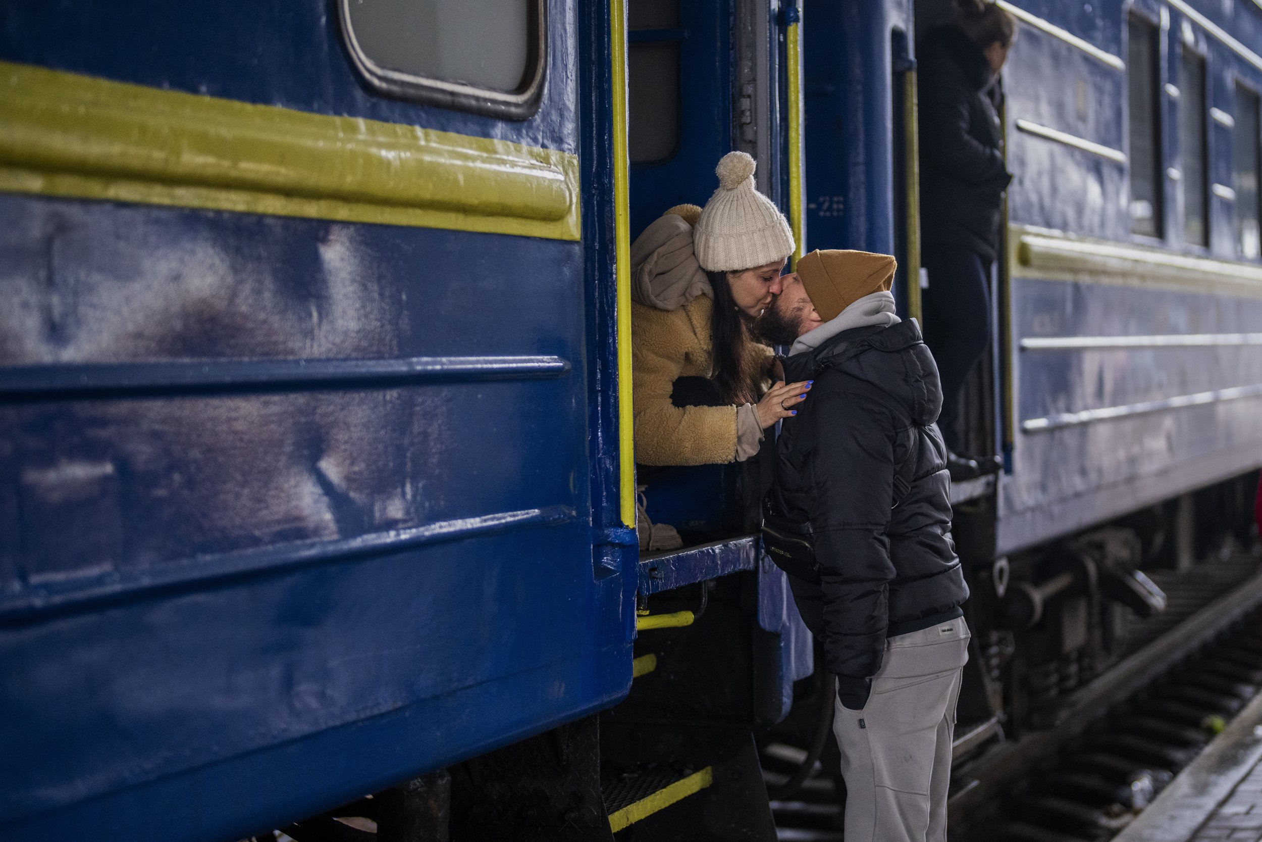  Stanislav, 40, kisses his wife Anna, 35, on a train to Lviv as they say goodbye at the Kyiv station, Ukraine, Thursday, March 3. 2022. Stanislav is staying to fight while his family is leaving the country to seek refuge in a neighboring country. (AP