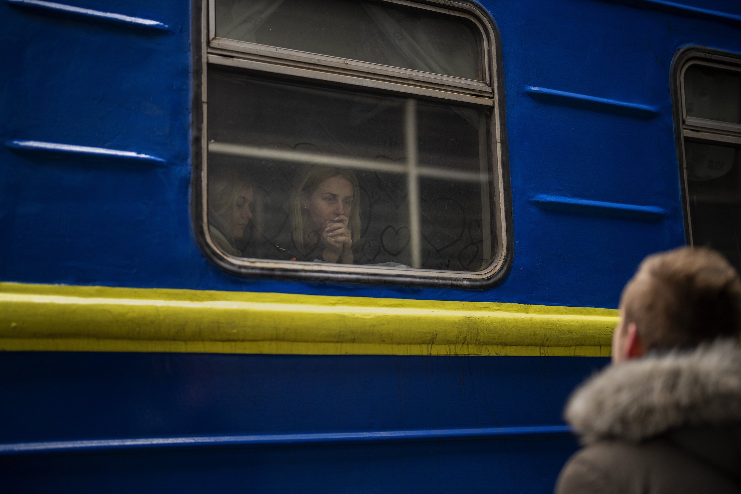  Bogdan, 41, says goodbye to his wife Lena, 35, on a train to Lviv at the Kyiv station, Ukraine, Thursday, March 3. 2022. Bogdan is staying to fight while his family is leaving the country to seek refuge in a neighboring country. (AP Photo/Emilio Mor