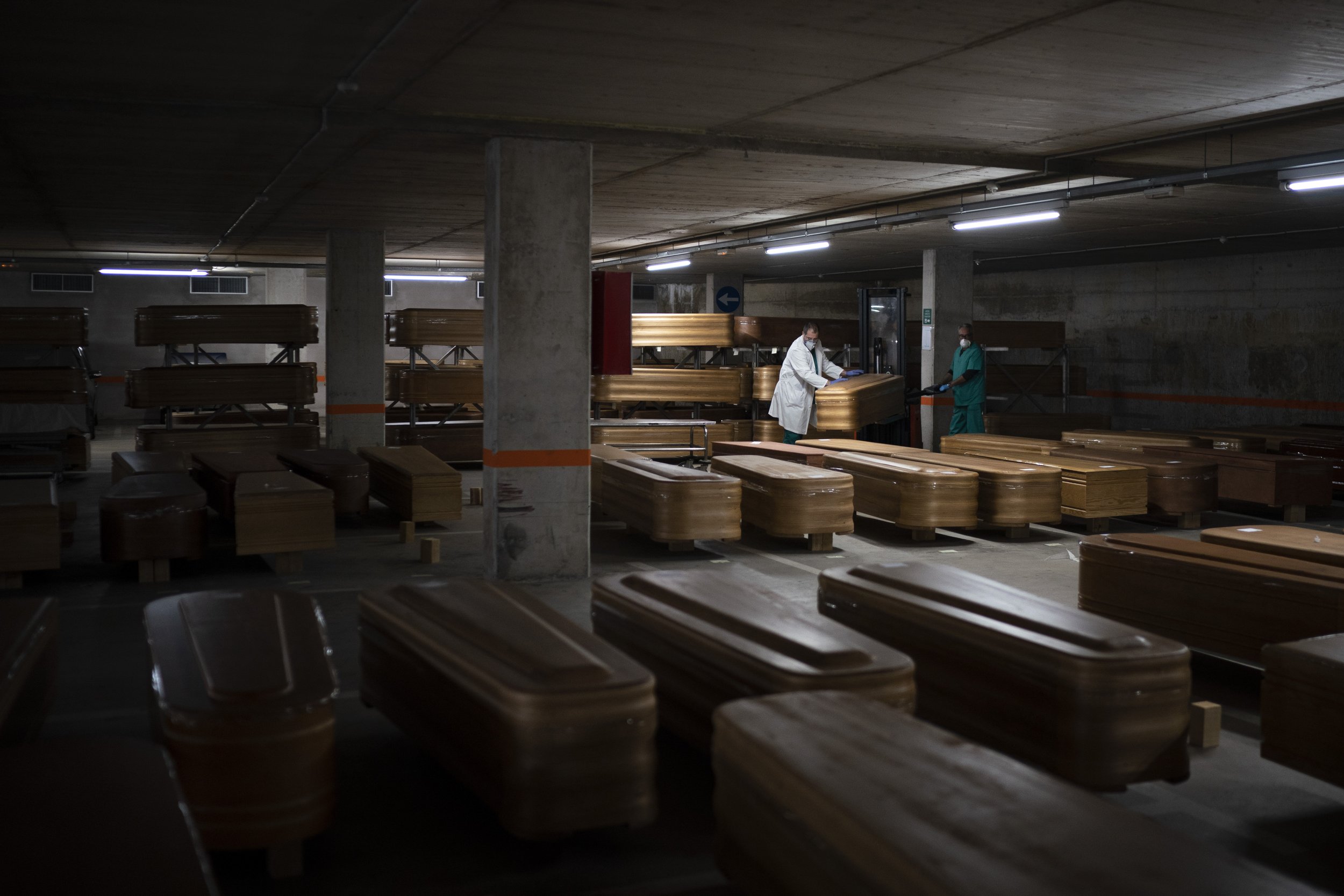  Coffins carrying the bodies of people who died of coronavirus and are stored waiting to be buried or incinerated in an underground parking lot at the Collserola funeral home in Barcelona, Spain, Thursday, April 2, 2020. (AP Photo/Felipe Dana) 