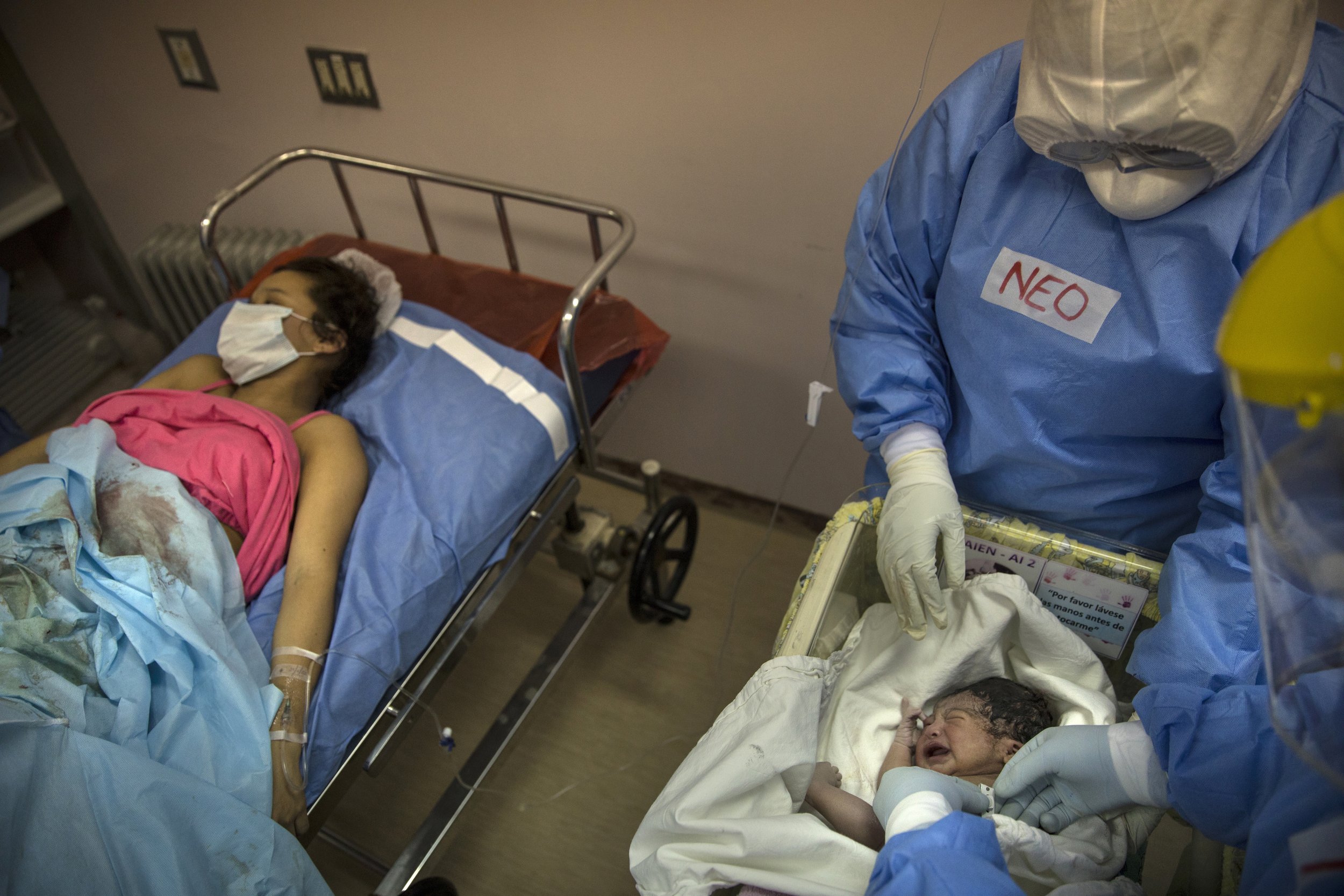 A neonatologist examines Maria Alvarez's newborn baby girl at the National Maternal Perinatal Institute in an isolated area reserved for mothers infected with COVID-19, in Lima, Peru, Wednesday, July 29, 2020. The 24-year-old first-time mother wept 