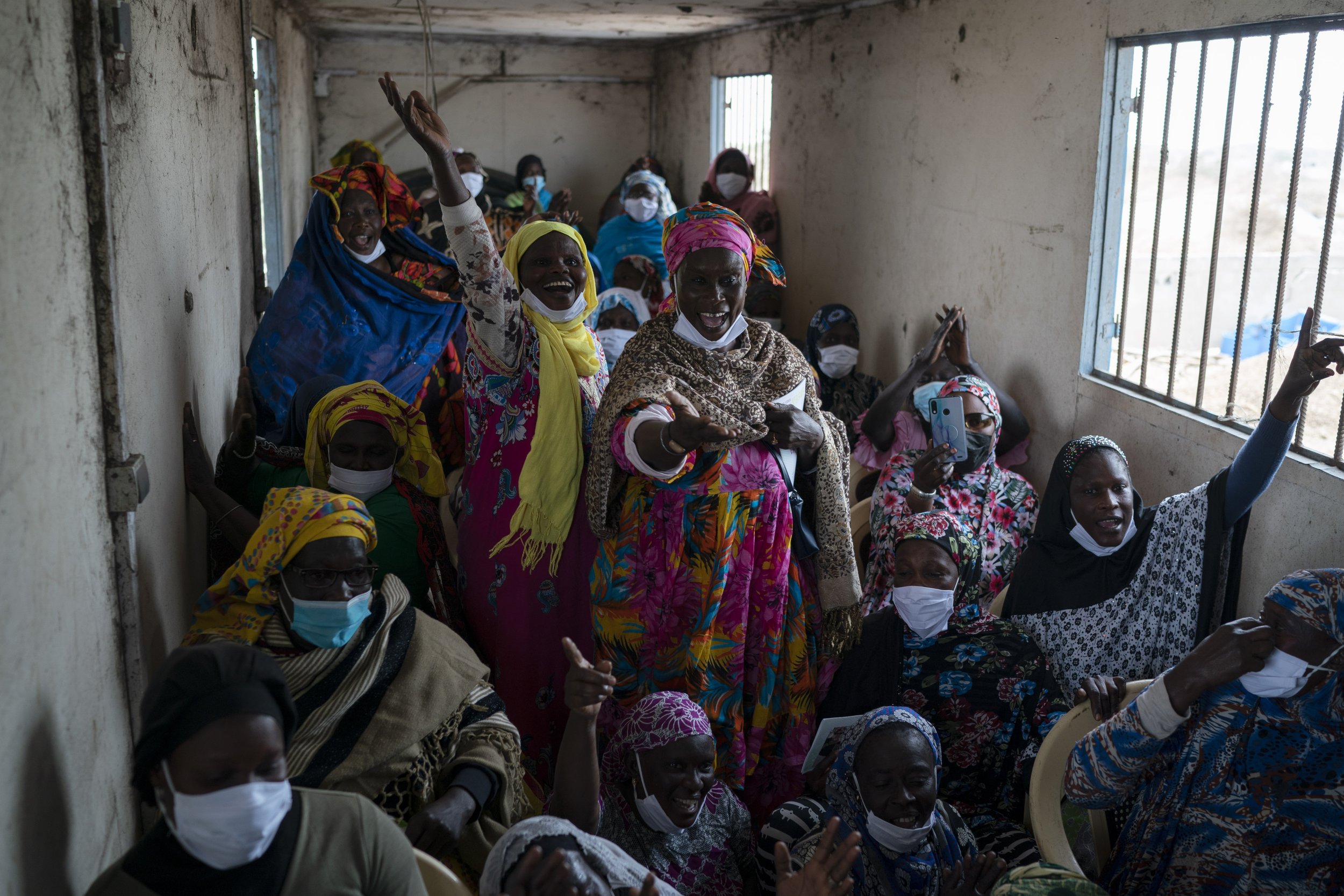  Siny Gueye, center left, is joined by other women fish processors to sing a blessing and thankful song at Bargny beach, east of Dakar, Senegal, Thursday April 1, 2021. (AP Photo/Leo Correa) 