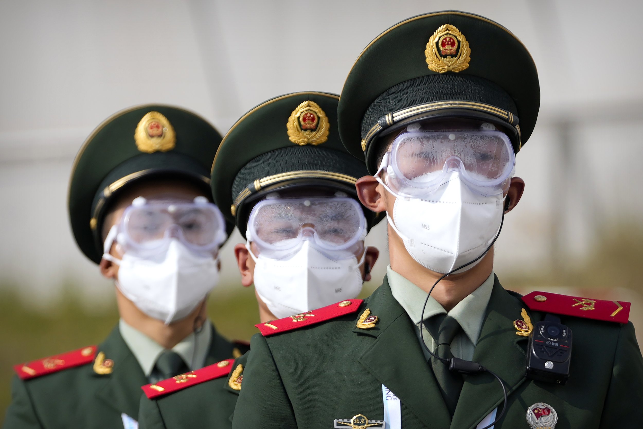  Chinese paramilitary police wearing goggles and face masks march in formation at the Yanqing National Sliding Center during an IBSF sanctioned race, a test event for the 2022 Winter Olympics, in Beijing, Monday, Oct. 25, 2021. A northwestern Chinese