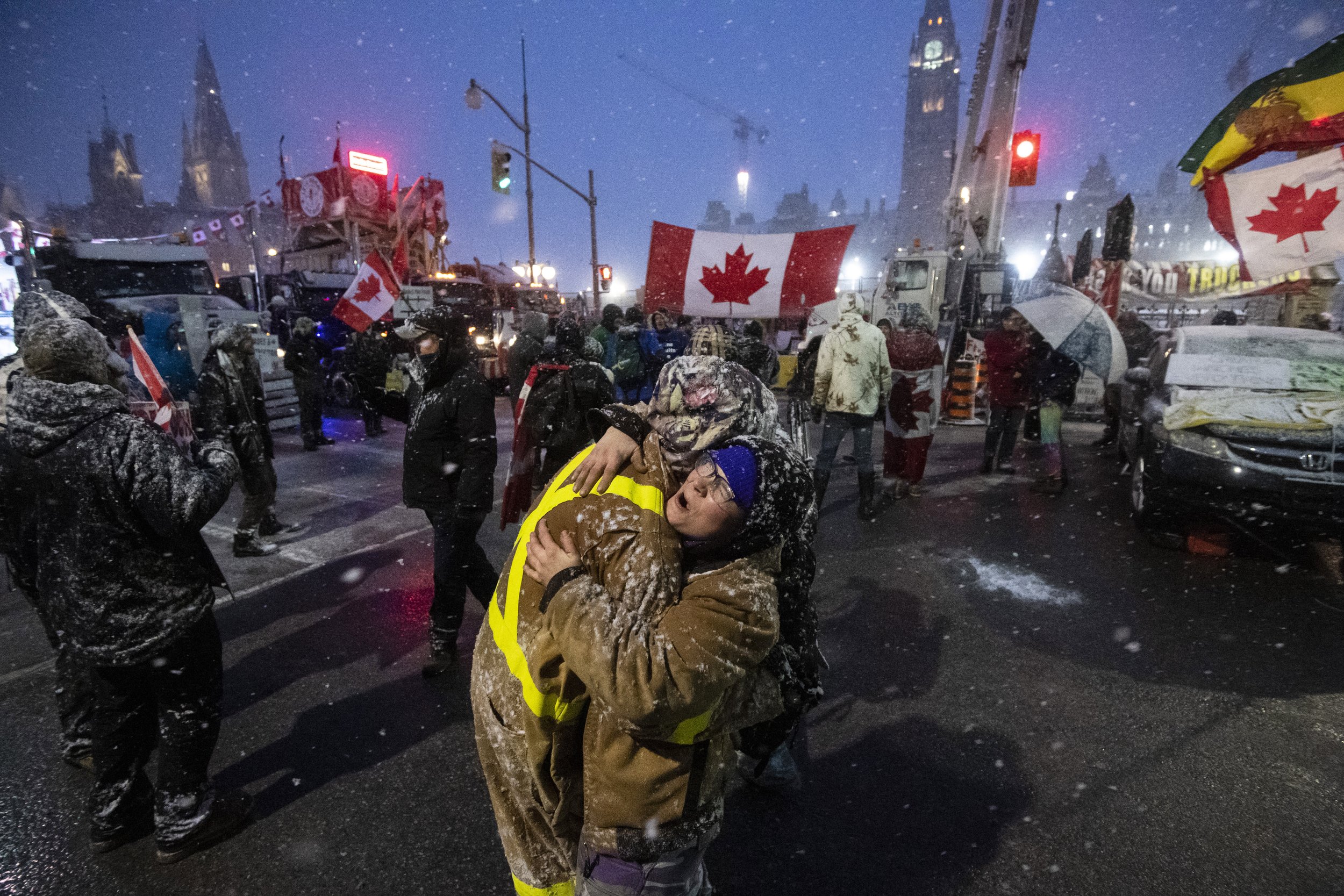  Protesters dance and embrace as a song plays over the speakers, during an ongoing protest against COVID-19 measures that has grown into a broader anti-government protest, in Ottawa, Ontario, on Thursday, Feb. 17, 2022. (Justin Tang/The Canadian Pres