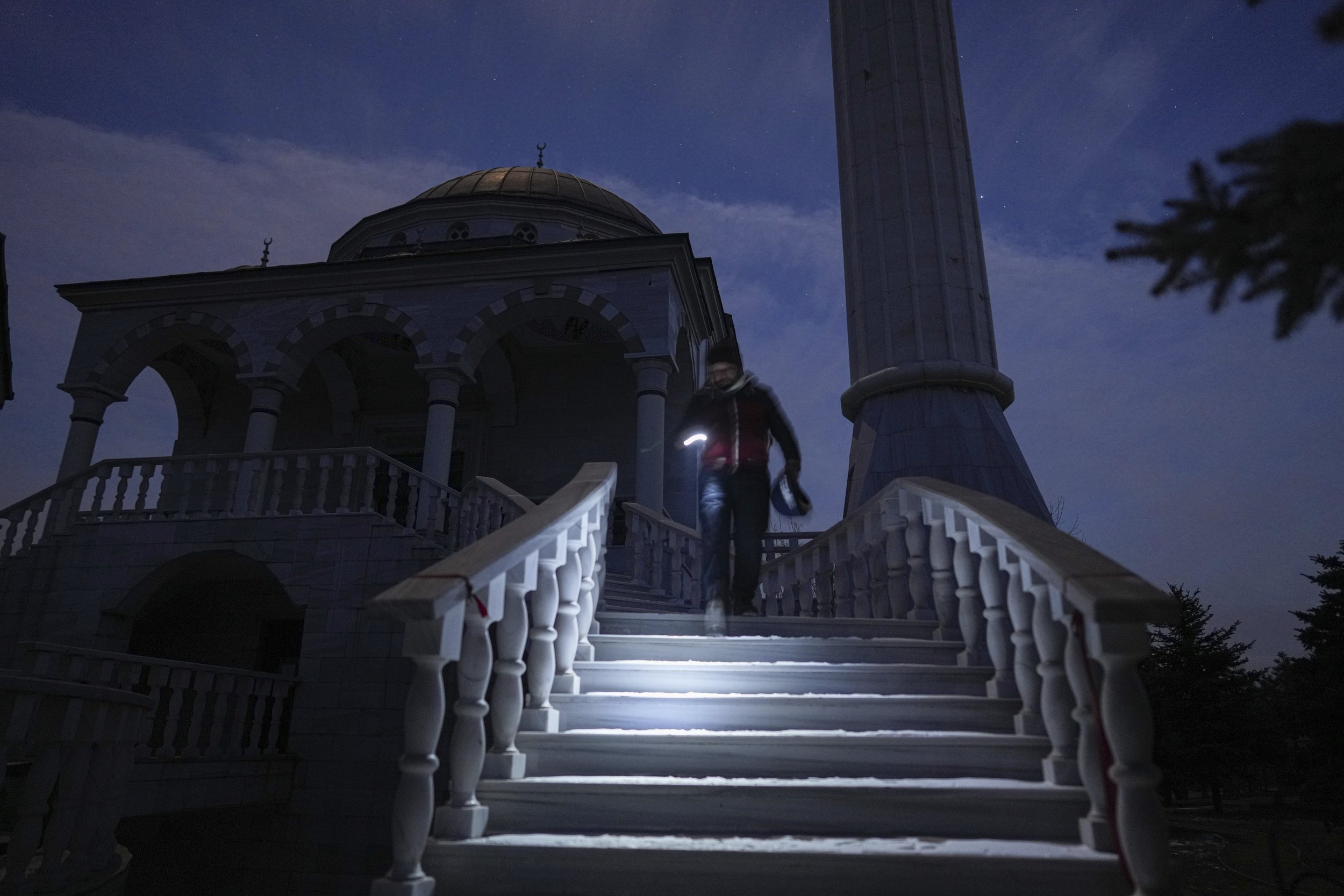  Turkish imam Mehmet Yuce walks down the steps after evening pray in a mosque in Mariupol, Ukraine, Saturday, March 12, 2022. The Ukrainian Embassy in Turkey says a group of 86 Turkish nationals, including 34 children, are among those sheltering in a