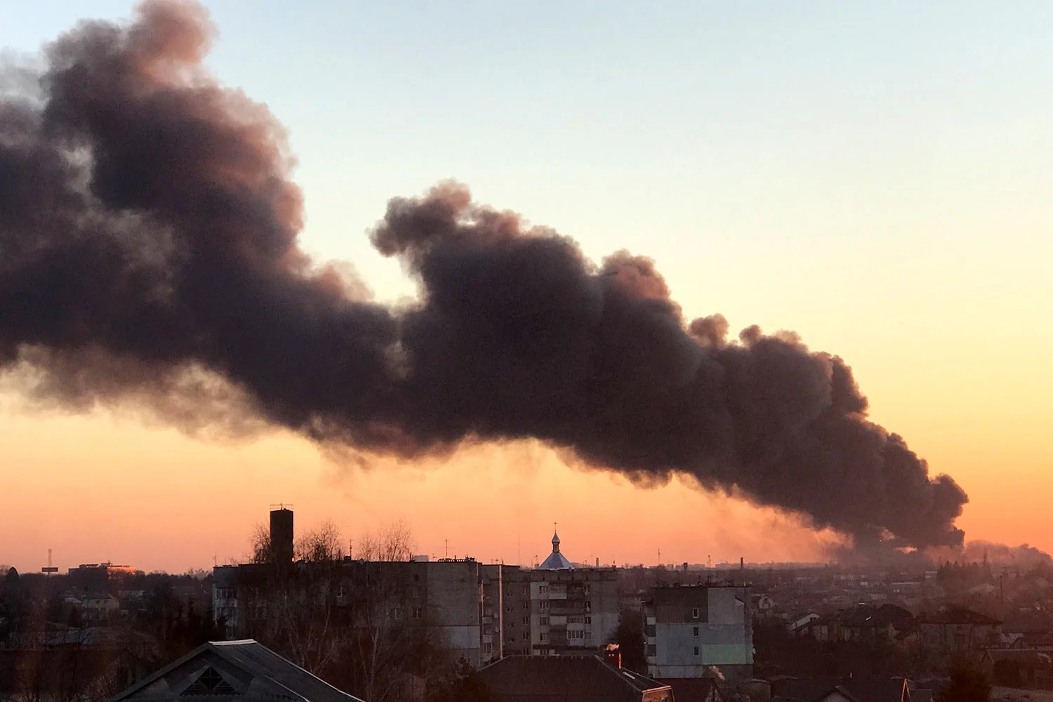  A cloud of smoke raises after an explosion in Lviv, western Ukraine, Friday, March 18, 2022. The mayor of Lviv says missiles struck near the city's airport early Friday. (AP Photo) 