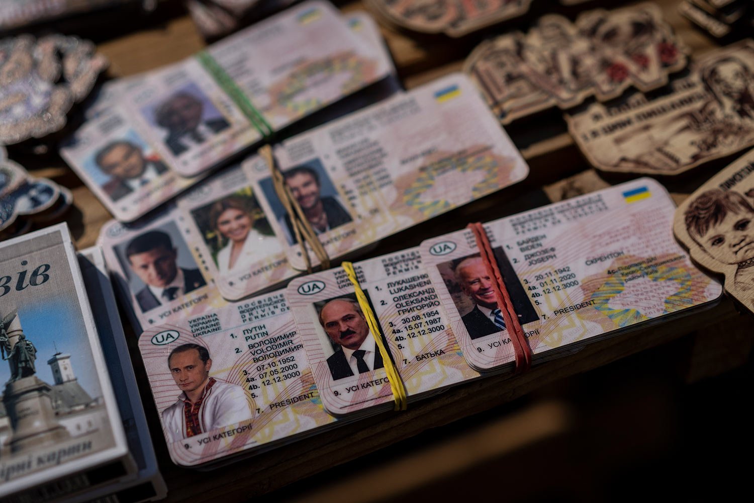  Fake IDs depicting Russian President Vladimir Putin, left, Belarusian President Alexander Lukashenko, center, and U.S. President Joe Biden sit for sale in a flea market in Lviv, western Ukraine, on Sunday, March 20, 2022. (AP Photo/Bernat Armangue) 