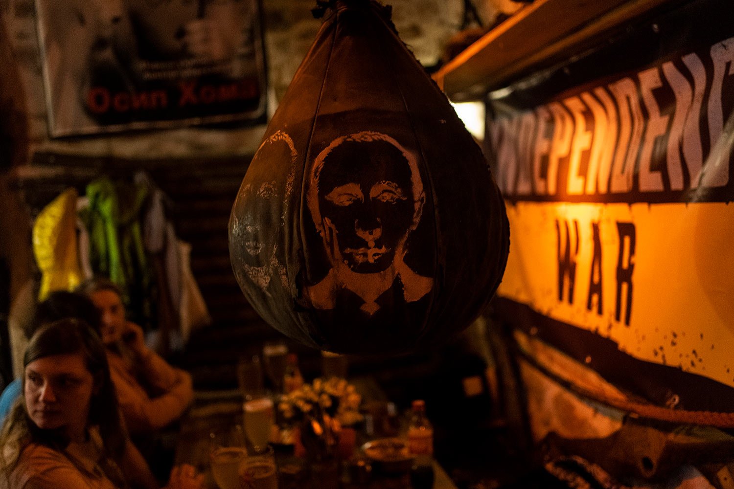  A boxing bag with a drawing of Russian President Vladimir Putin's face hangs inside a bar in downtown Lviv, western Ukraine, Tuesday, March 22, 2022. (AP Photo/Bernat Armangue) 