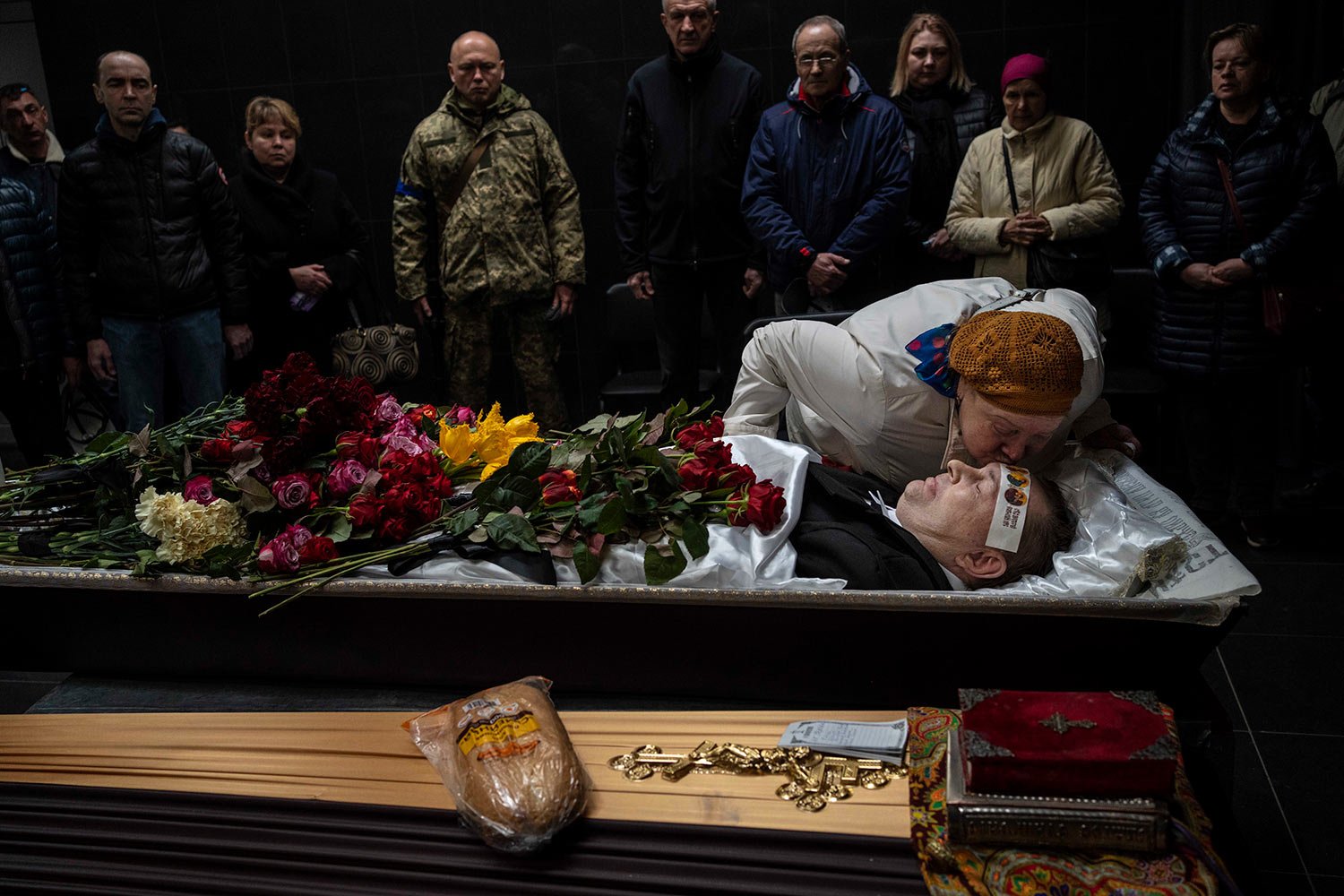  Natalya kisses her brother Sergiy Muravyts'kyi, 61, who was killed by Russian soldiers in the village of Mriya, which means Dream, in Ukrainian, during a ceremony before his cremation in Baikove cemetery, Kyiv, Ukraine, Thursday, March 24, 2022. (AP