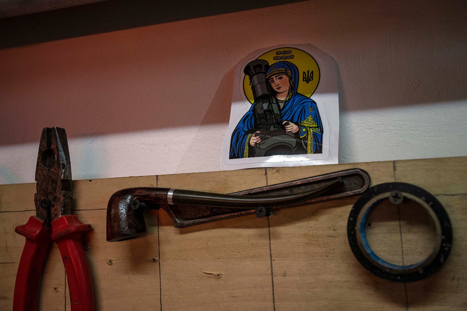  A sticker with the image known as "Saint Javelin" depicting a saint holding a Javelin, an American-made portable anti-tank missile system, is displayed in an artists co-living studio space that is used as a bomb shelter and a place to help the Terri