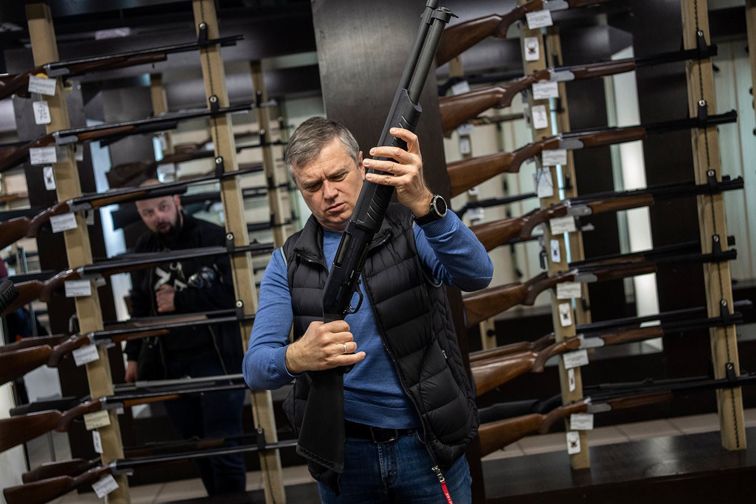  A customer checks his rifle in a gun shop in Lviv, western Ukraine, Wednesday, March 23, 2022. The rush for guns and gun training continued in the western city of Lviv. (AP Photo/Bernat Armangue) 