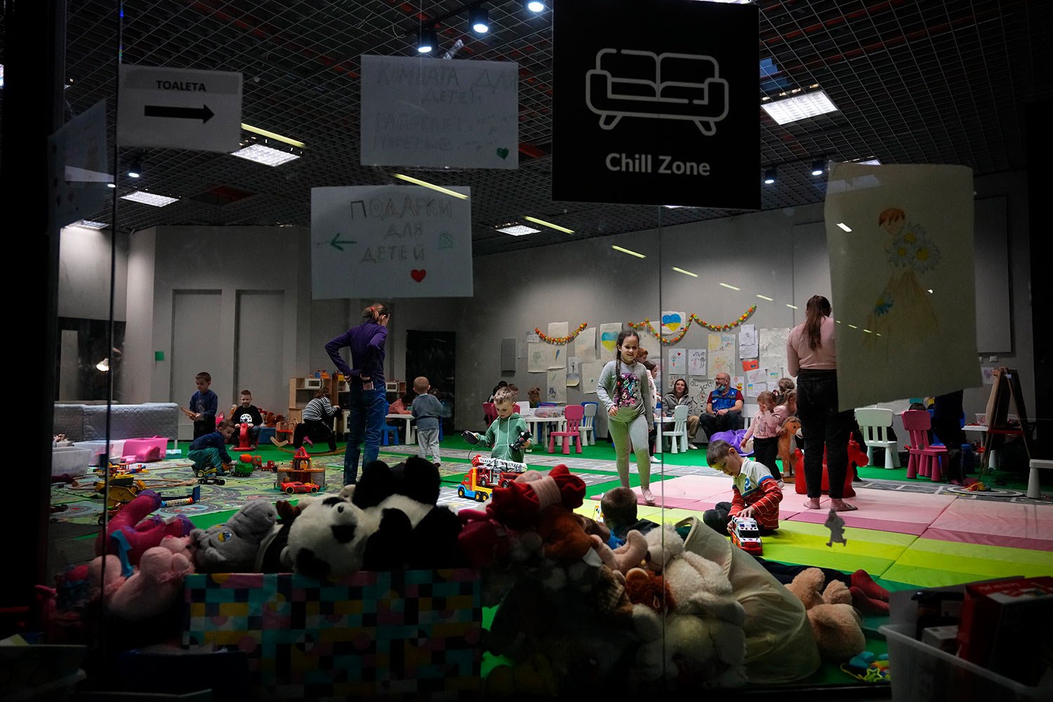  Children from Ukraine play at an exhibition hall, turned into a refugee center in Nadarzyn, near Warsaw, Poland, on Wednesday, March 23, 2022. (AP Photo/Petr David Josek) 