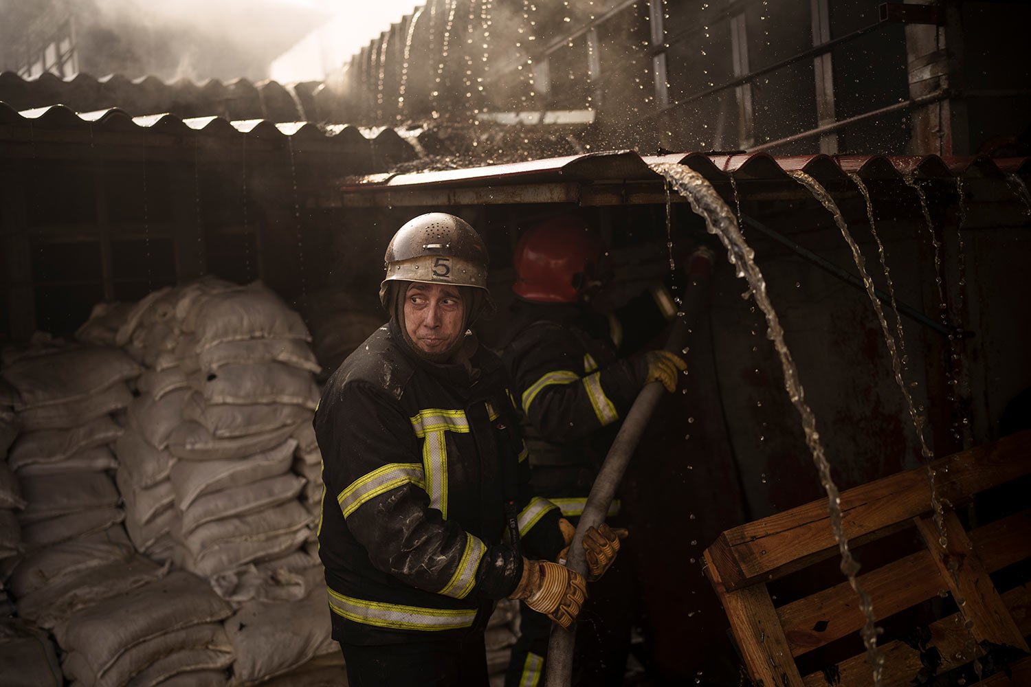  Firefighters battle a blaze following a Russian attack in Kharkiv, Ukraine, Friday, March 25, 2022. (AP Photo/Felipe Dana) 