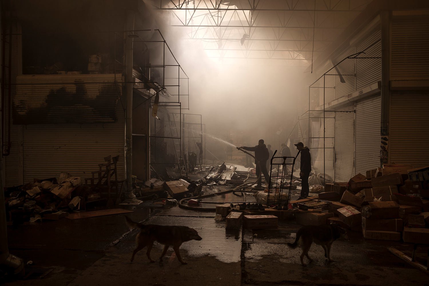  People try to extinguish a fire in a market after a Russian attack in Kharkiv, Ukraine, Friday, March 25, 2022. (AP Photo/Felipe Dana) 