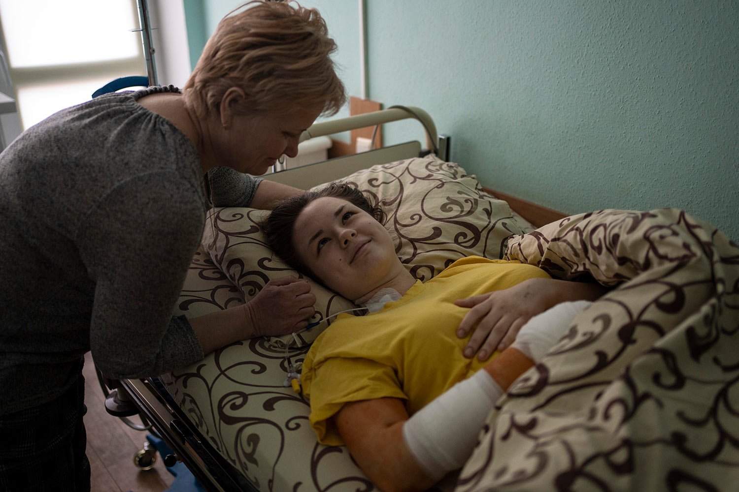  Nastya Kuzyk, 20, is comforted by her mother Svitlana, 50, while recovering in a hospital in Kyiv, Ukraine, Friday, March 25, 2022, with injuries caused after a Russian attack in her city of Chernihiv. (AP Photo/Rodrigo Abd) 