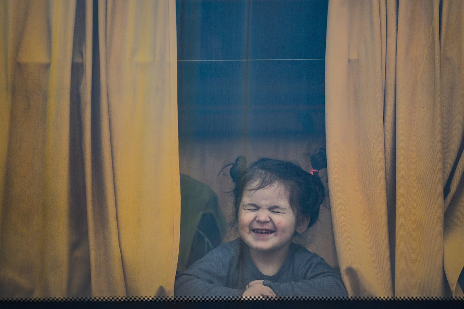  A child refugee fleeing the war from neighboring Ukraine with her family reacts as she sits in a bus after crossing the border by ferry at the Isaccea-Orlivka border crossing, in Romania, Friday, March 25, 2022. (AP Photo/Andreea Alexandru) 