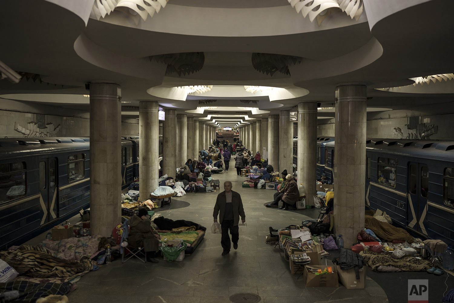  People stay in a metro station being used as a bomb shelter in Kharkiv, Ukraine, Saturday, March 26, 2022. With the invasion now in its second month, Russian forces have seemingly stalled on many fronts and are even losing previously taken ground to