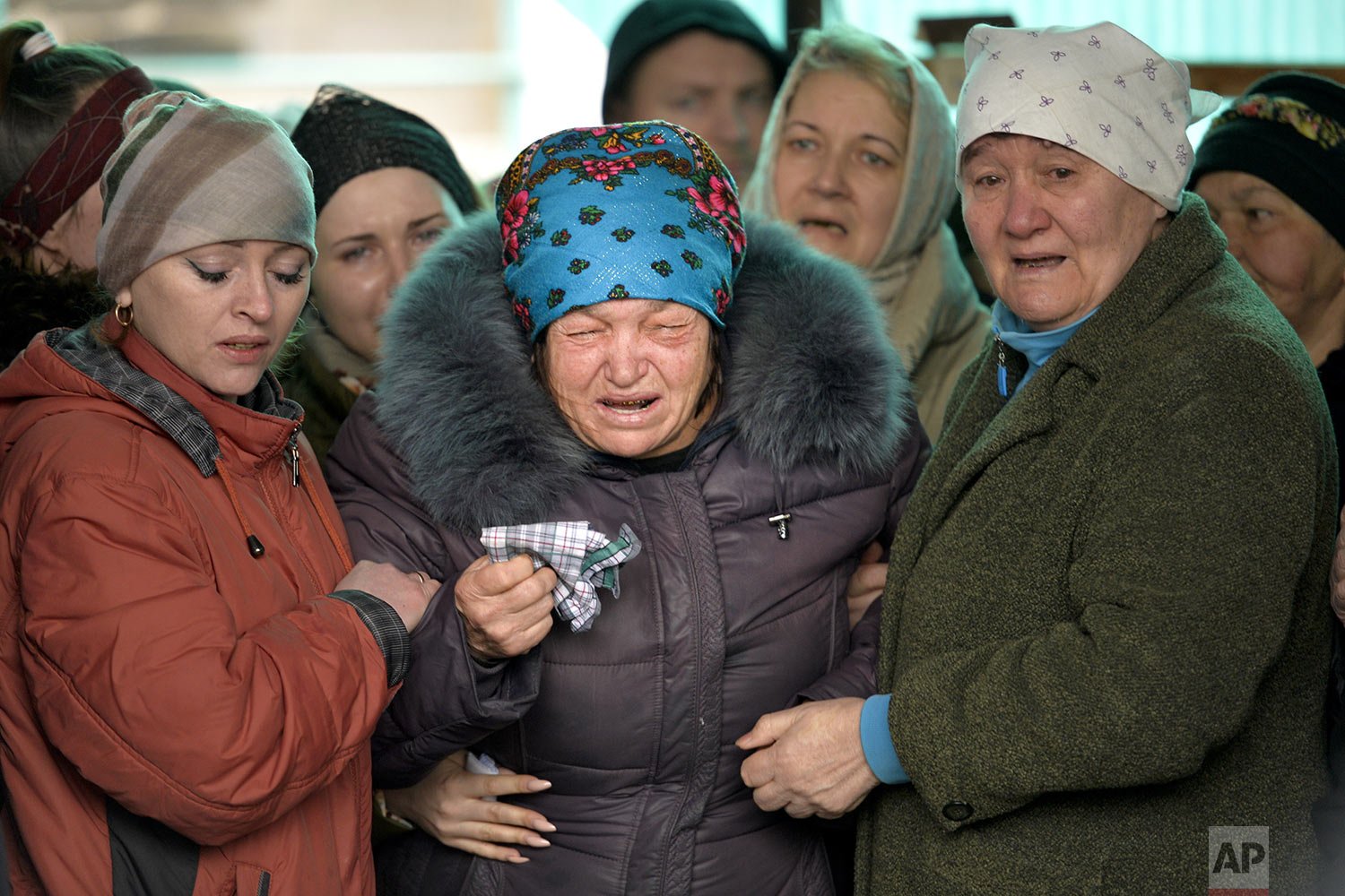  The mother of Russian Army soldier Rustam Zarifulin, who was killed fighting in Ukraine, cries surrounded by relatives during a farewell ceremony in his hometown of Kara-Balta, west of Bishkek, Kyrgyzstan, Sunday, March 27, 2022. (AP Photo/Vladimir 