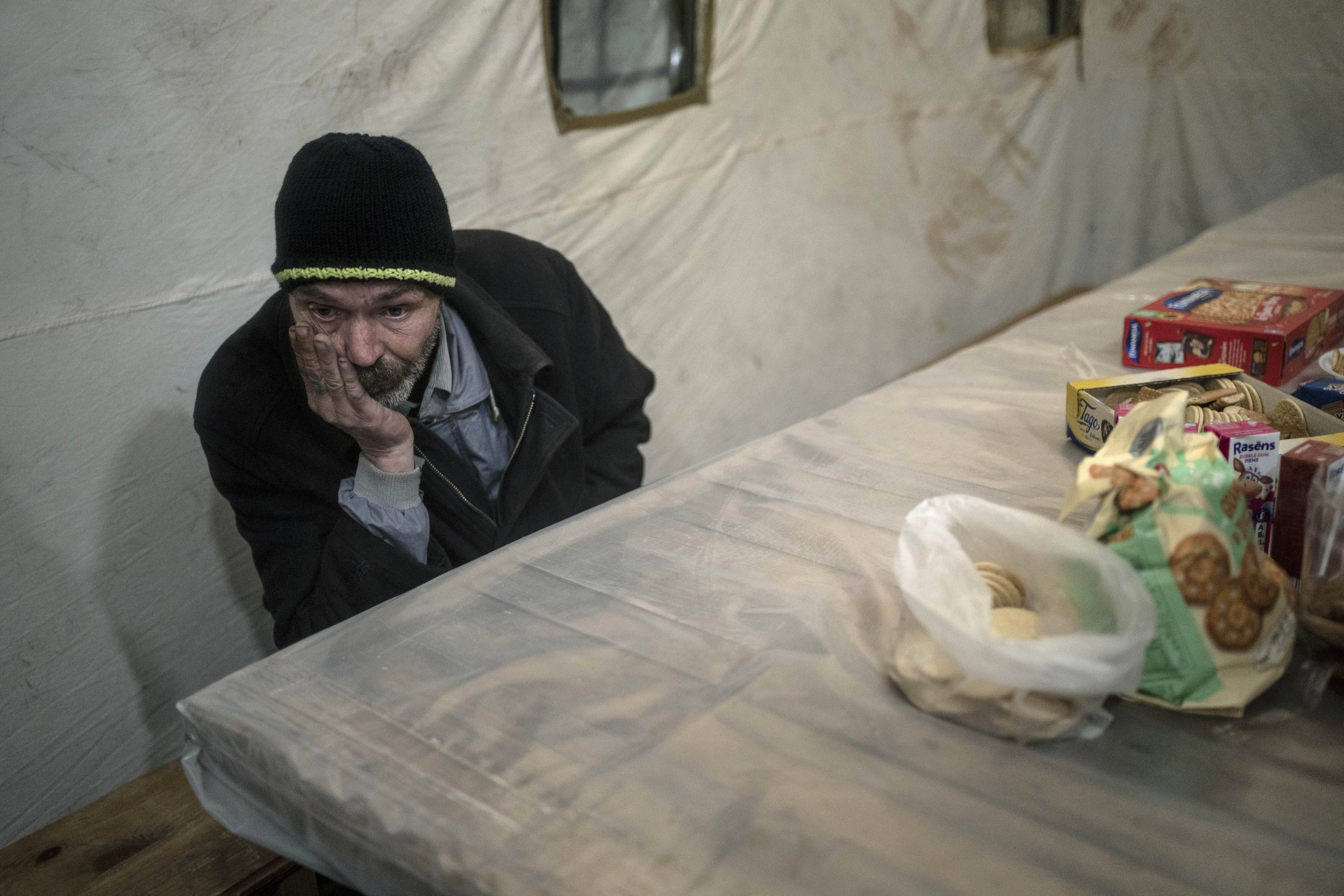  Borya, 58, evacuated from the town of Baryshivka by the Ukrainian government due to heavy fighting, waits inside a tent after arriving in Brovary, on the outskirts of Kyiv, Ukraine, Tuesday, March 29, 2022. (AP Photo/Rodrigo Abd) 