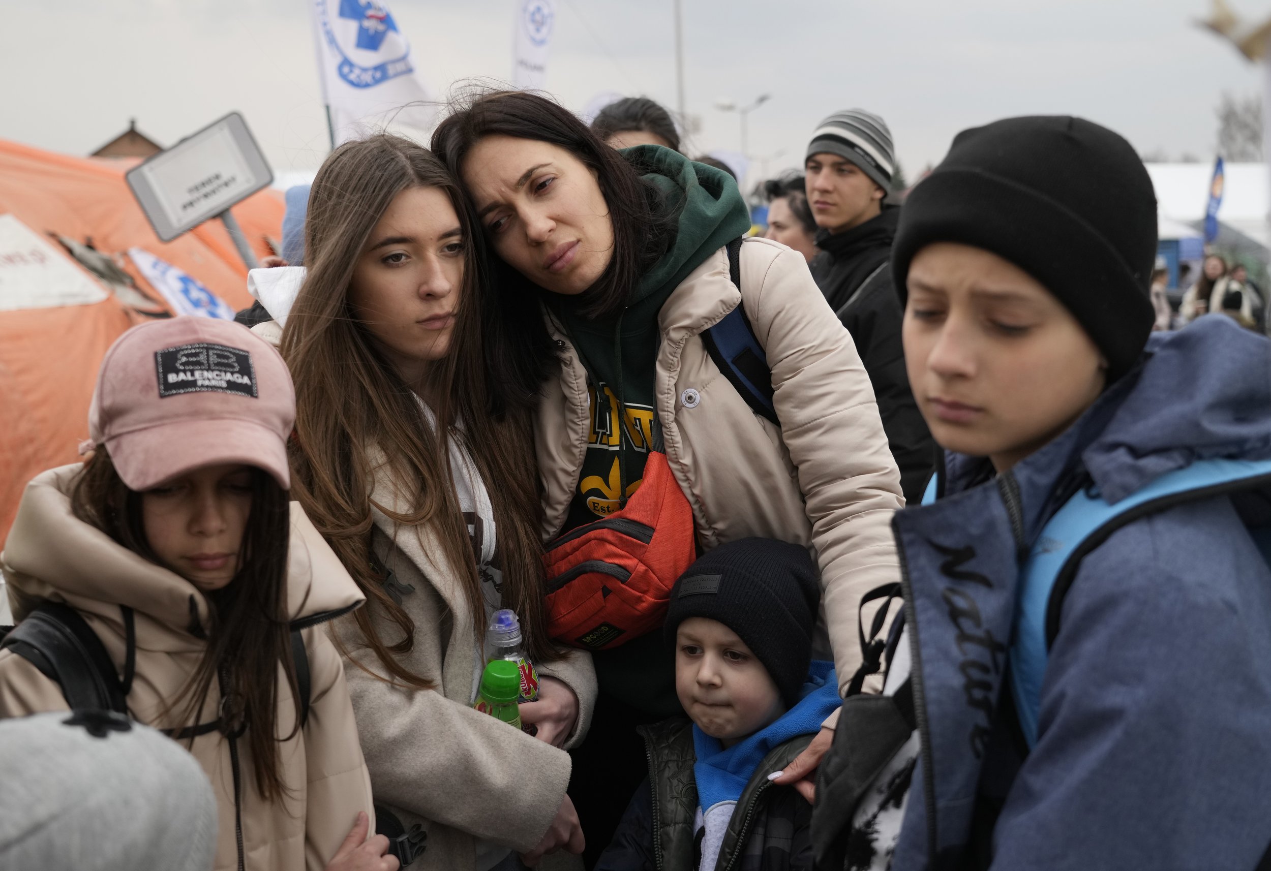  Refugees wait in a queue, after fleeing the war from neighboring Ukraine at the border crossing in Medyka, southeastern Poland, on Tuesday, March 29, 2022. (AP Photo/Sergei Grits) 