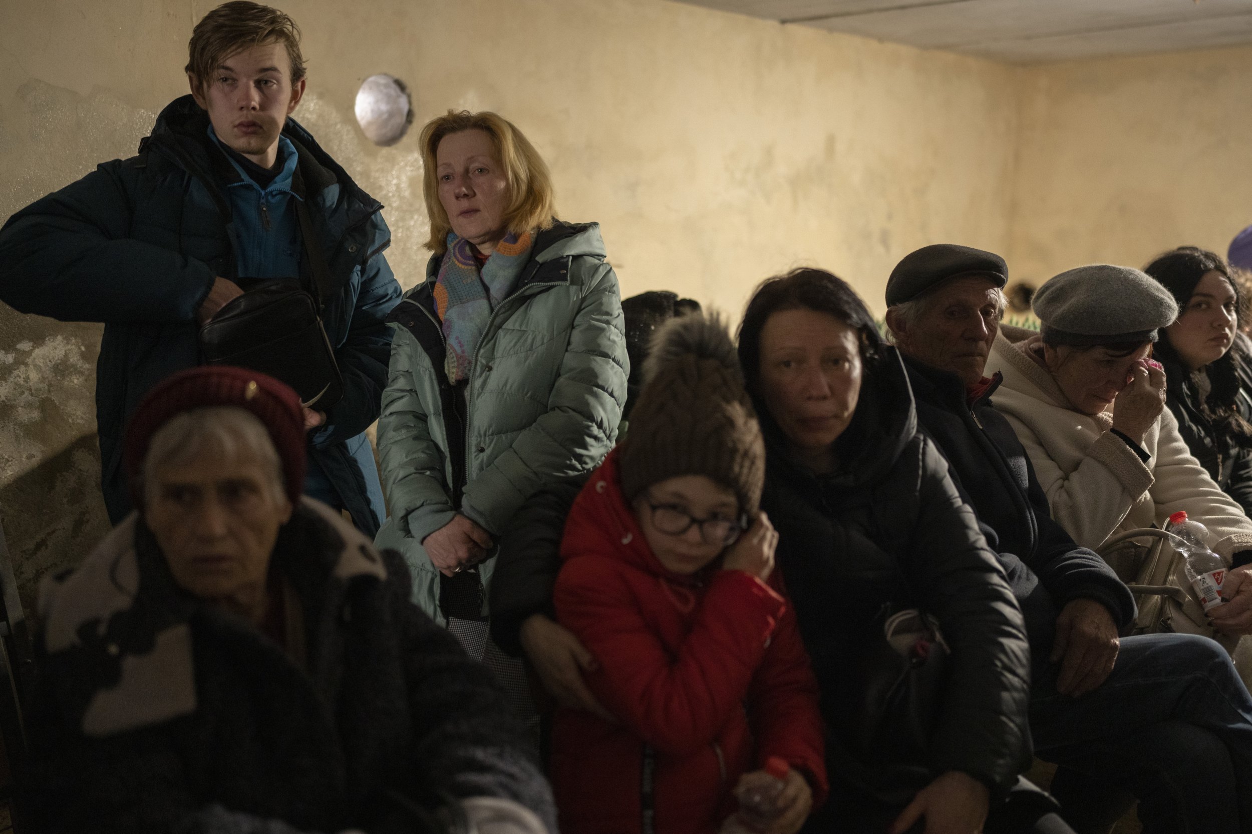  People hide in a basement of a church which is used as a bomb shelter, after fleeing from nearby villages that have been attacked by the Russian army, in the town of Bashtanka, Mykolaiv district, Ukraine,on Thursday, March 31, 2022. (AP Photo/Petros