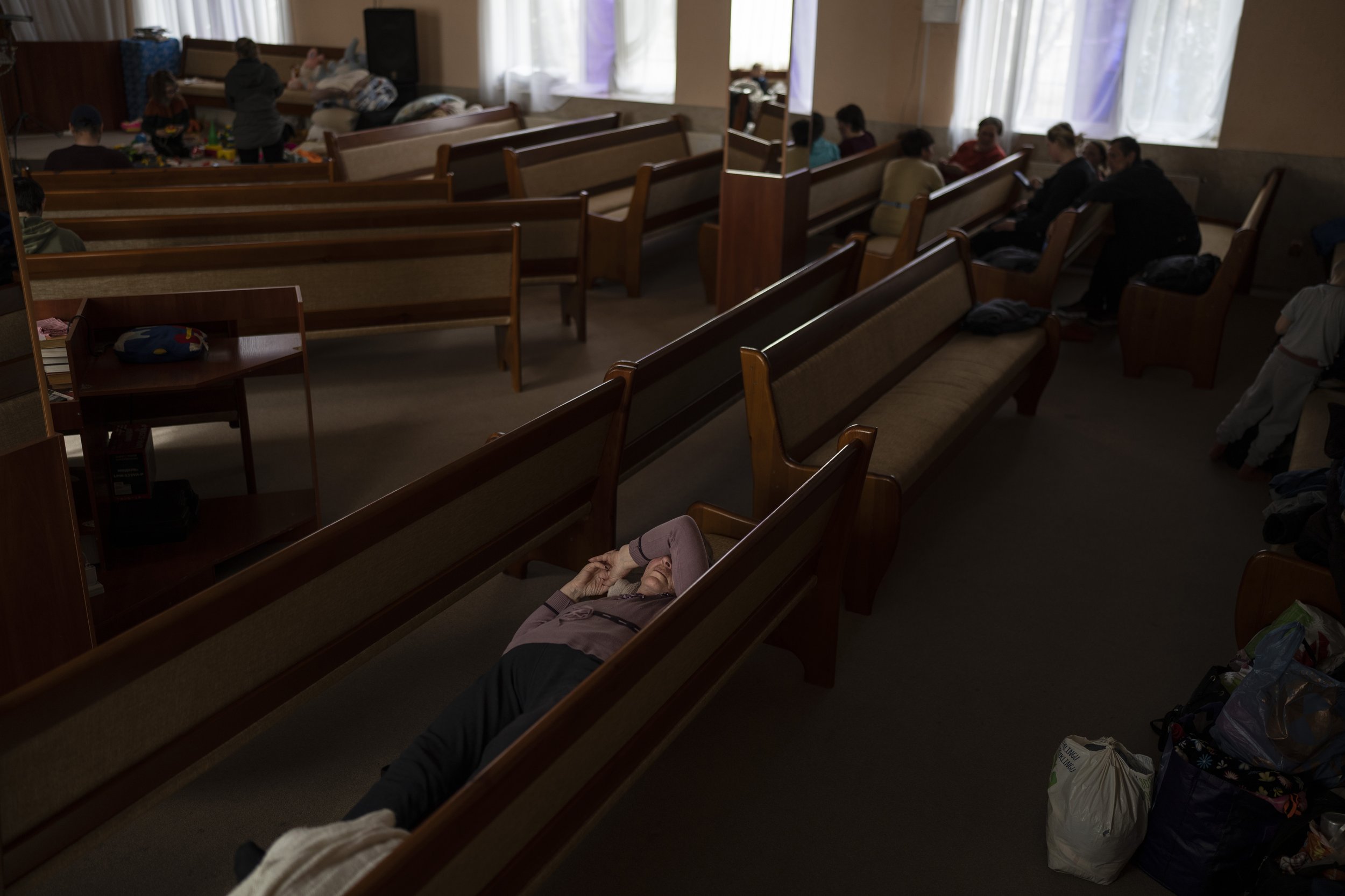  People take shelter inside a church after fleeing from nearby villages that have been attacked by the Russian army, in the town of Bashtanka, Mykolaiv district, Ukraine, on Thursday, March 31, 2022. (AP Photo/Petros Giannakouris) 