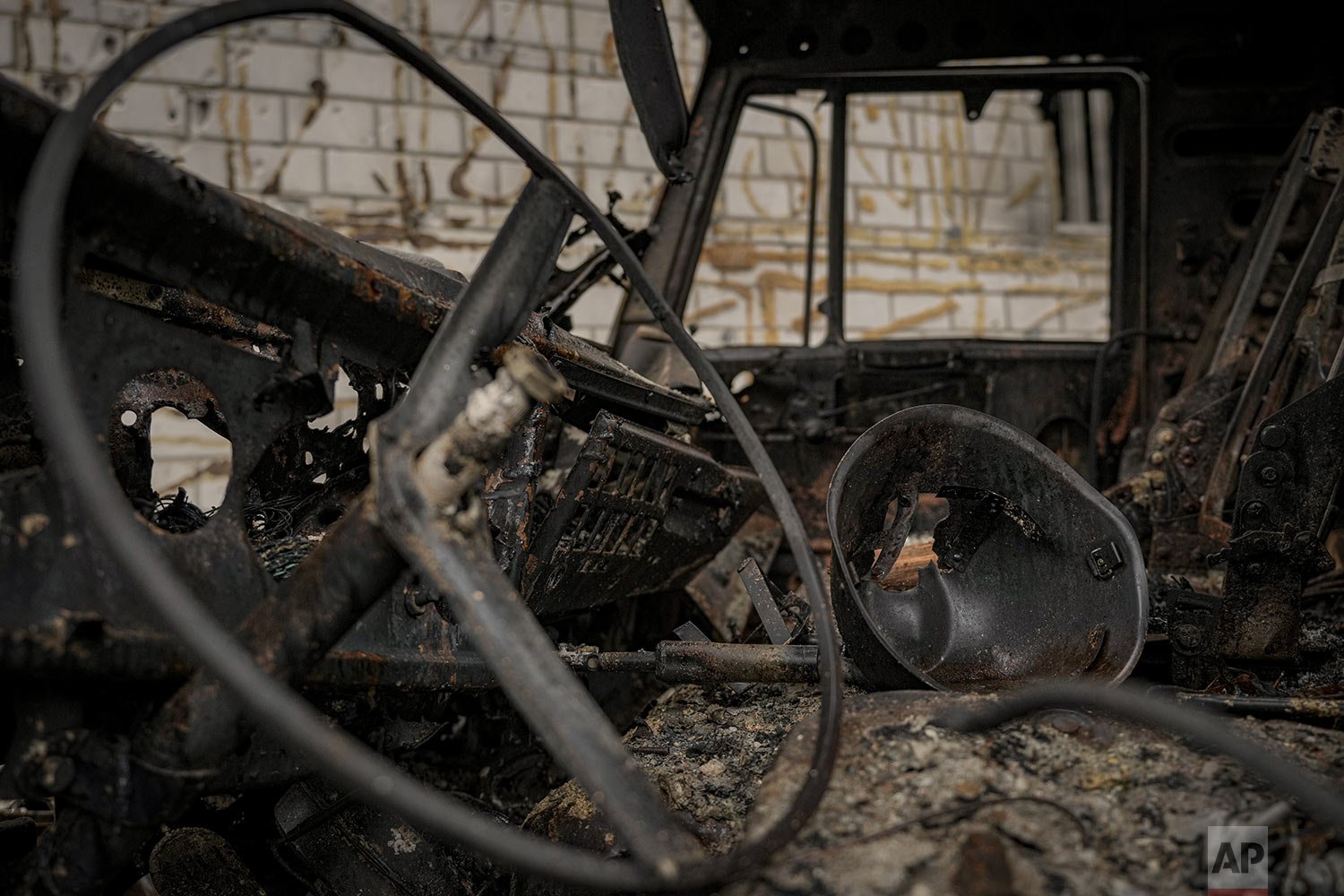  A pierced helmet lies in the cabin of a Russian military truck, destroyed during fighting between Russian and Ukrainian forces, outside of Kyiv, Ukraine, Friday, April 1, 2022. (AP Photo/Vadim Ghirda) 