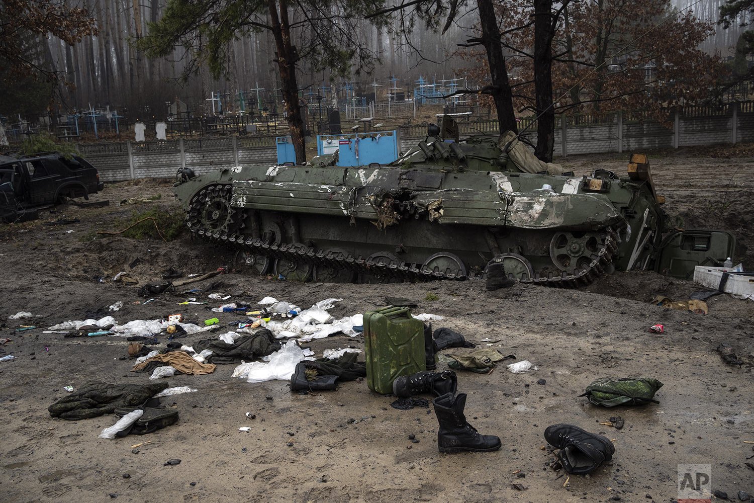  Military gear left behind by Russian soldiers lay scattered near a tank during a military sweep by Ukrainian soldiers after the Russians withdrawal from the area on the outskirts of Kyiv, Ukraine, Friday, April 1, 2022. (AP Photo/Rodrigo Abd) 