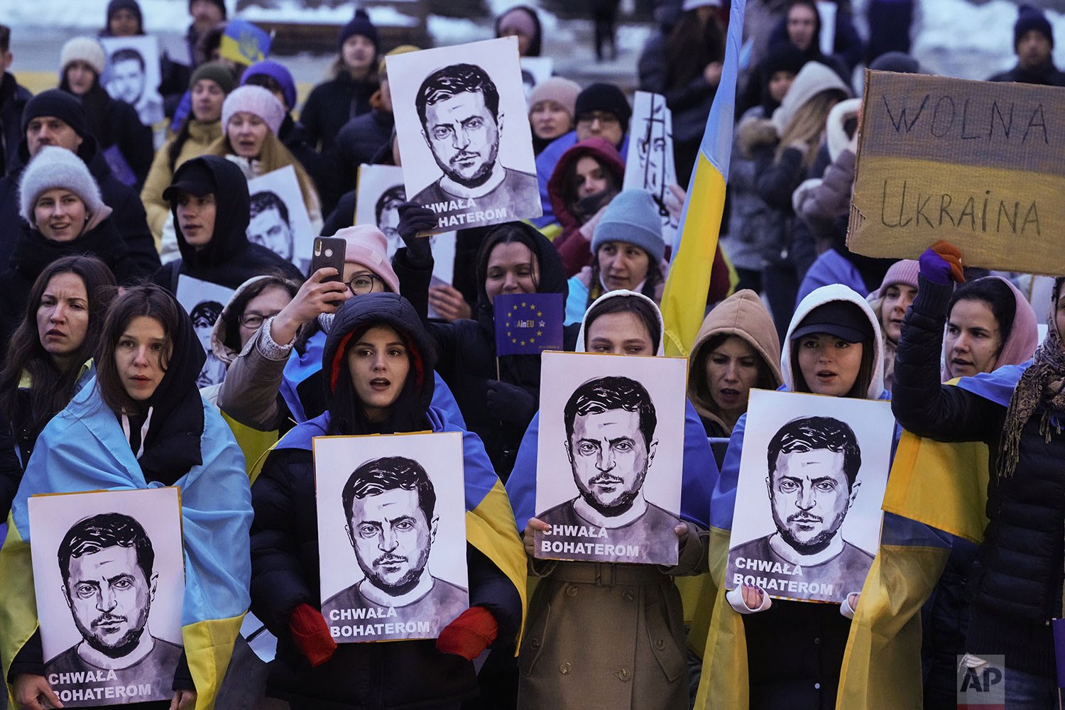  People hold portraits of Ukrainian President Volodymyr Zelenskyy during an anti-war rally in front of the Palace of Culture and Science in Warsaw, Poland, Saturday, April 2, 2022. (AP Photo/Czarek Sokolowski) 