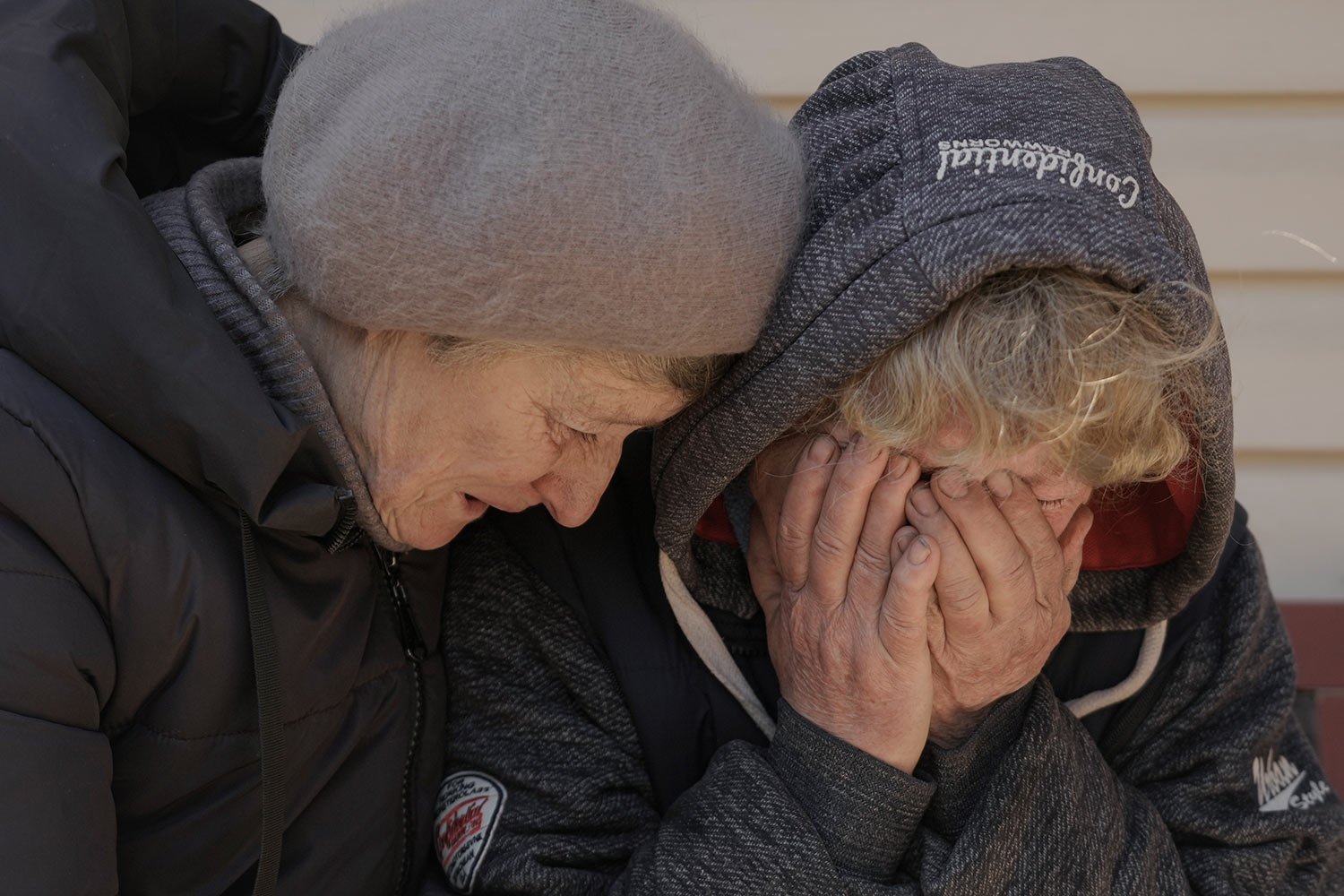  A neighbor comforts Natalya, whose husband and nephew were killed by Russian forces, as she cries in her garden in Bucha, Ukraine, Monday, April 4, 2022. (AP Photo/Vadim Ghirda) 