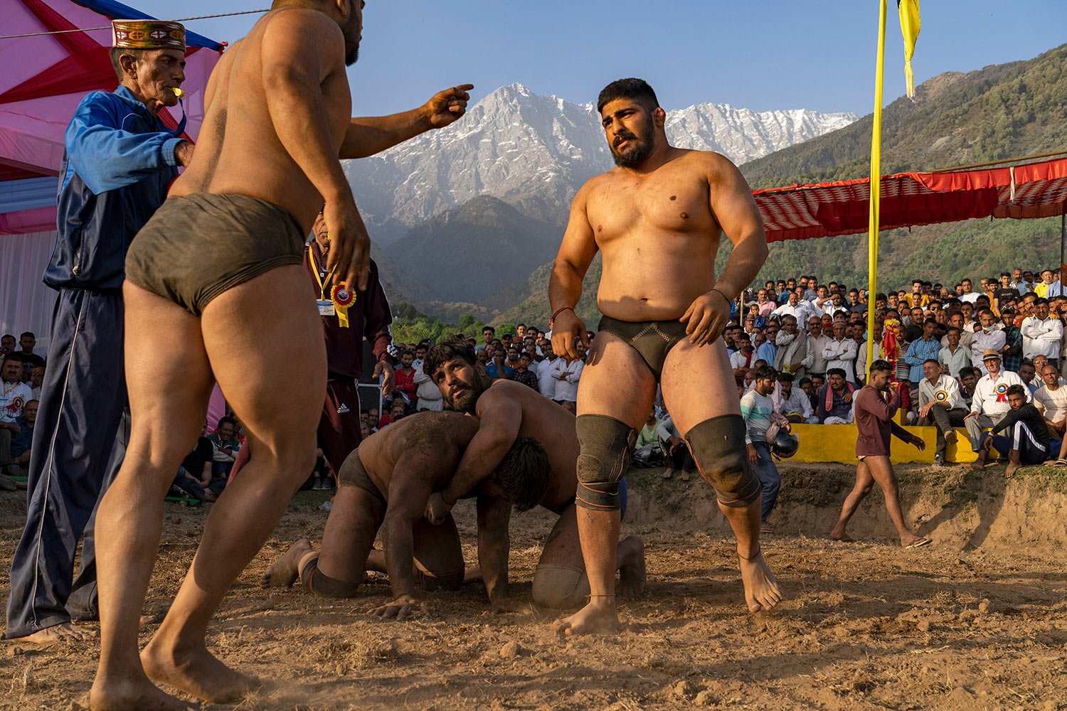  A wrestler points his finger at another as they compete for a cash prize at a local fair in Dharmsala, India, Tuesday, March 29, 2022.  (AP Photo/Ashwini Bhatia) 