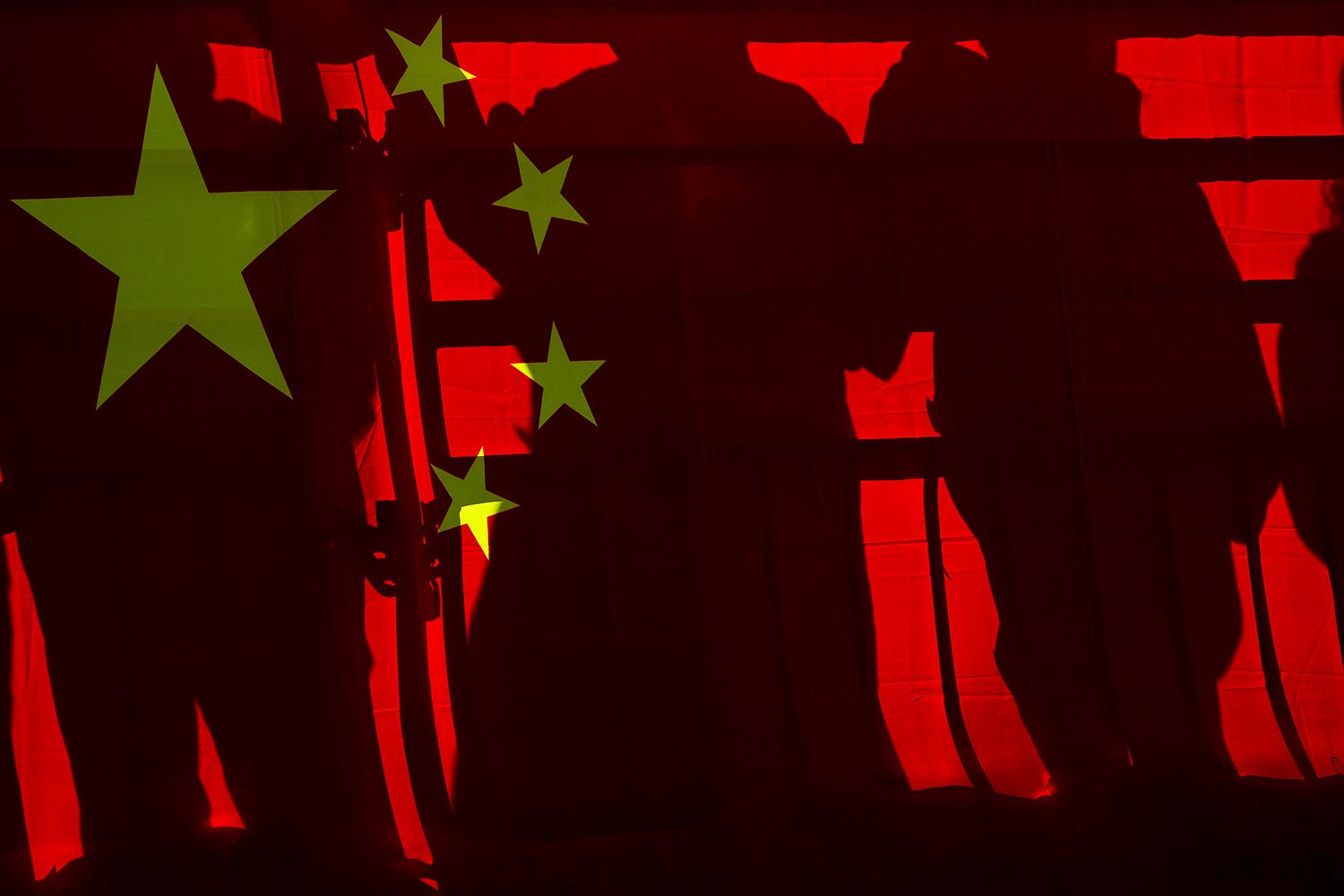  Spectators cast shadows on a Chinese national flag at a viewing platform during the men's and women's Alpine downhill at the 2022 Winter Paralympics, Saturday, March 5, 2022, in the Yanqing district of Beijing. (AP Photo/Andy Wong) 