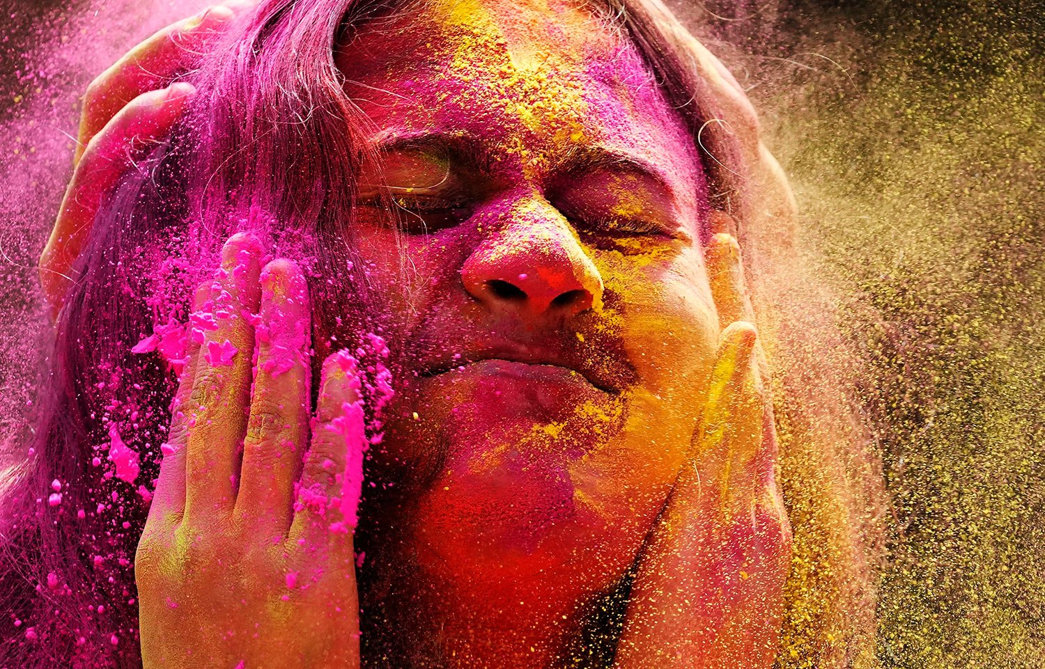  Colored powder is smeared on the face of a reveller during celebration marking Holi, the Hindu festival of colors, in Mumbai, India, Friday, March 18, 2022. (AP Photo/ Rajanish Kakade) 