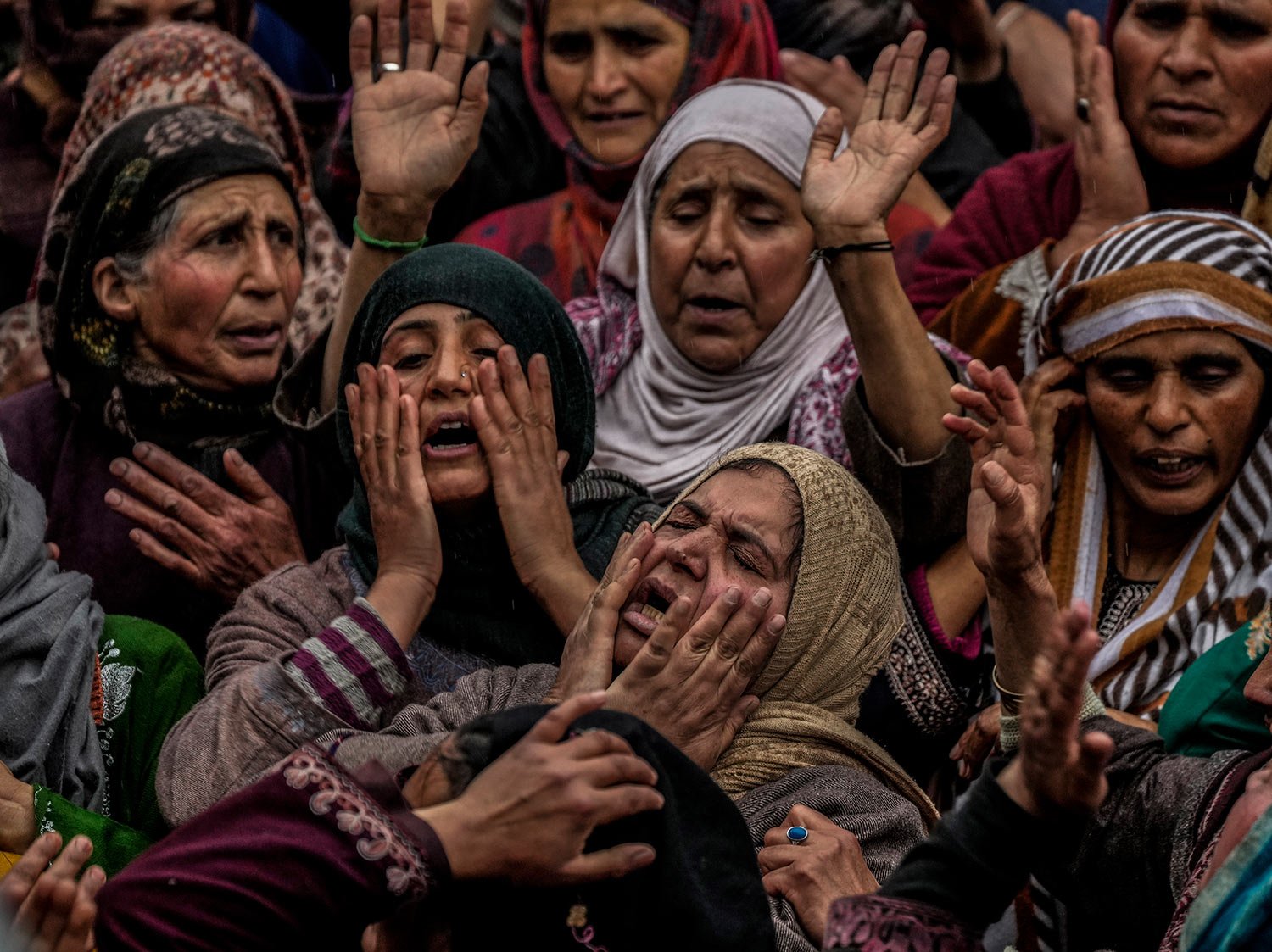  Family members and relatives mourn near the body of Rafia Nazir, a young Kashmiri woman killed in grenade attack, during her funeral in Srinagar, Indian-controlled Kashmir, Monday, March 7, 2022. (AP Photo/Mukhtar Khan) 