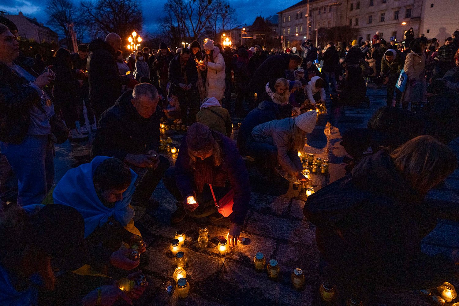  People light candles forming the shape of Ukraine's map, in memory of those who have died, in front of the Taras Shevchenko monument, in Lviv, western Ukraine, Tuesday, April 5, 2022. (AP Photo/Nariman El-Mofty) 