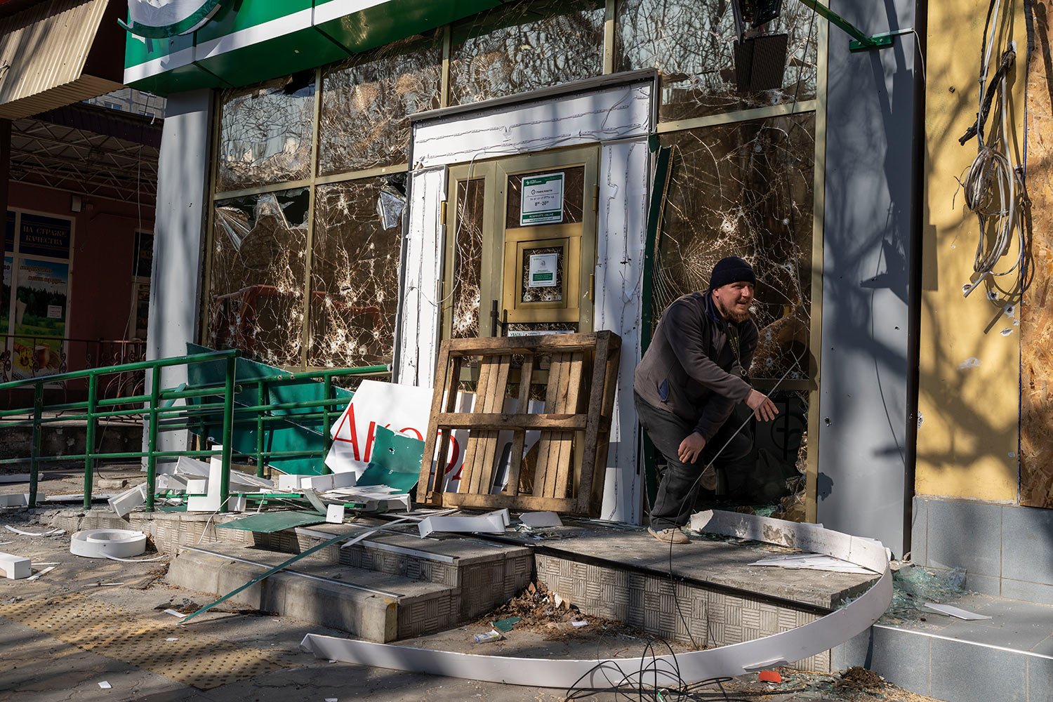  A man exits a damaged pharmacy following a bombing that killed several civilians, in Mykolaiv Ukraine, Tuesday, April 5, 2022. (AP Photo/Petros Giannakouris) 