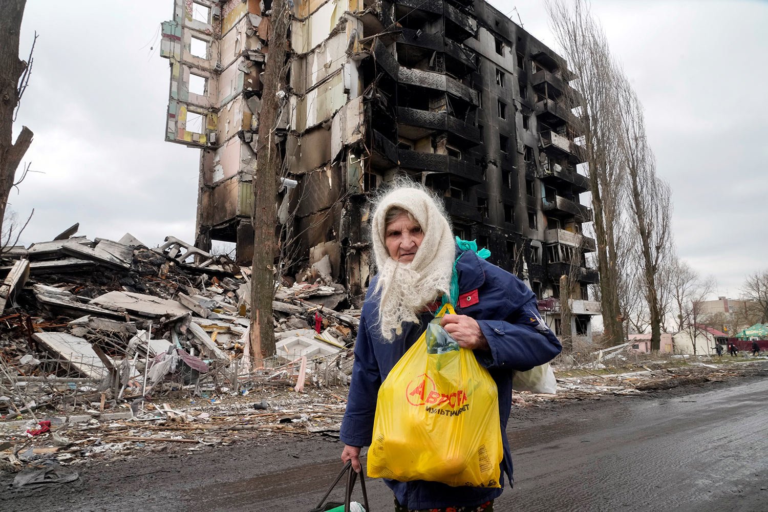  An elderly woman walks by an apartment building destroyed in the Russian shelling in Borodyanka, Ukraine, Wednesday, April 6, 2022. (AP Photo/Efrem Lukatsky) 