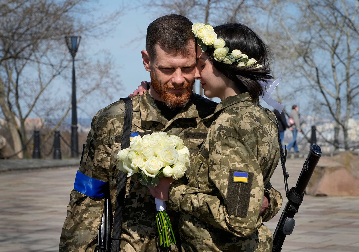  Ukrainian soldiers Anastasia and Vyacheslav embrace prior to their wedding ceremony in a city park in Kyiv, Ukraine, Thursday, April 7, 2022. (AP Photo/Efrem Lukatsky) 