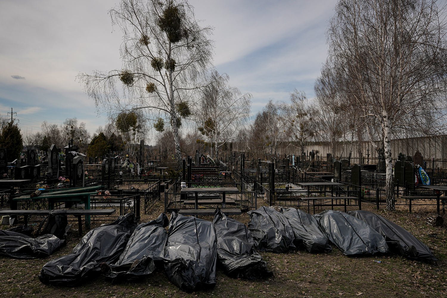 Bodies retrieved by municipal workers from the town are placed on the ground at a cemetery in Bucha, Ukraine, Thursday, April 7, 2022. (AP Photo/Vadim Ghirda) 