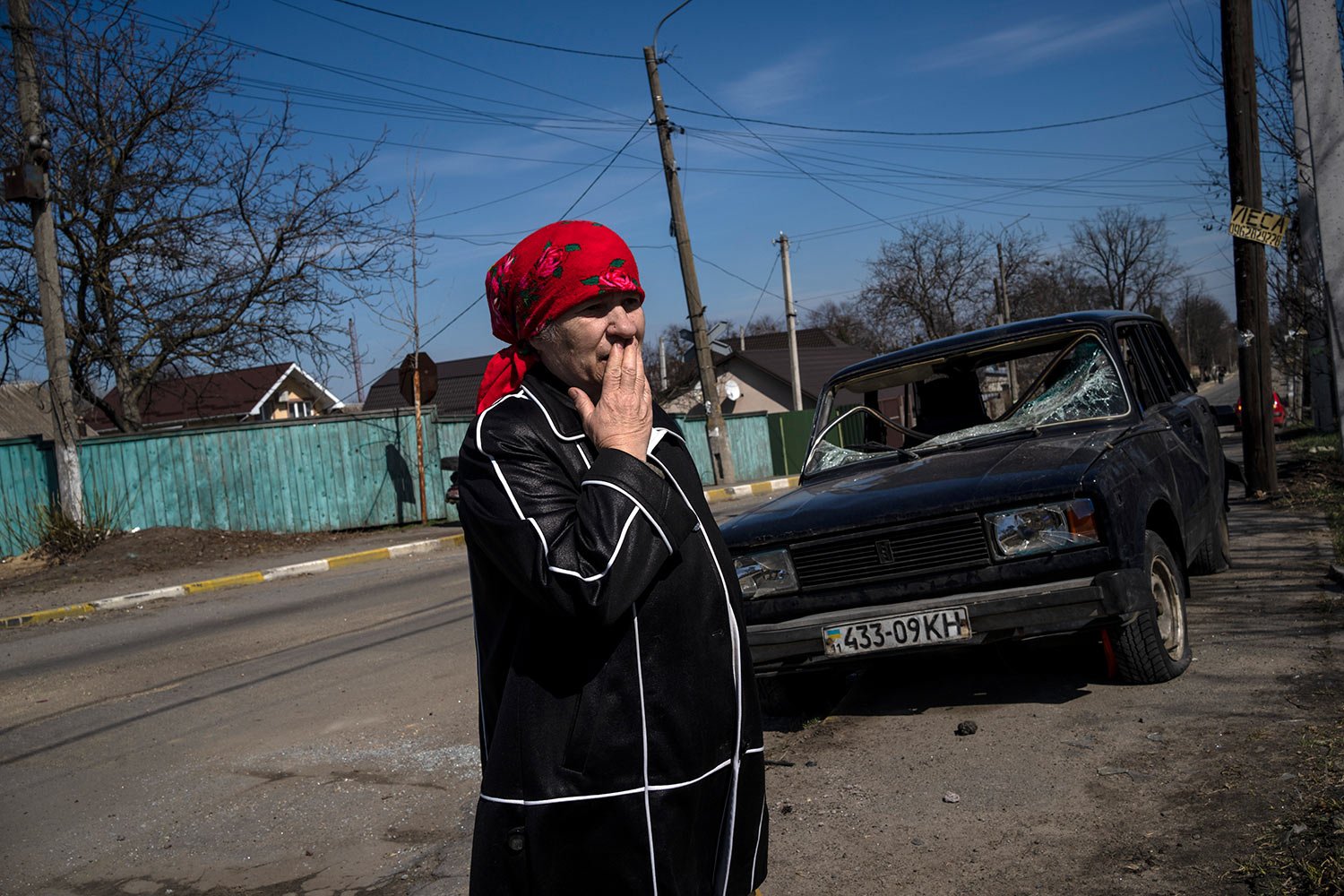  A woman talks to journalists outside her house in Bucha, outskirts of Kyiv, Ukraine, Thursday, April 7, 2022. (AP Photo/Rodrigo Abd) 
