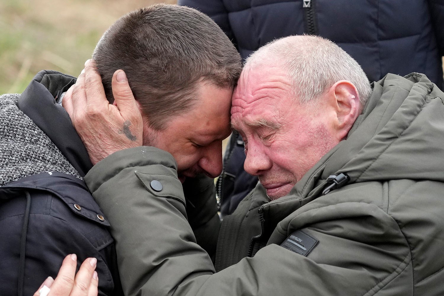  Relatives cry at the mass grave of civilians killed during Russian occupation in Bucha, on the outskirts of Kyiv, Ukraine, Friday, April 8, 2022. (AP Photo/Efrem Lukatsky) 